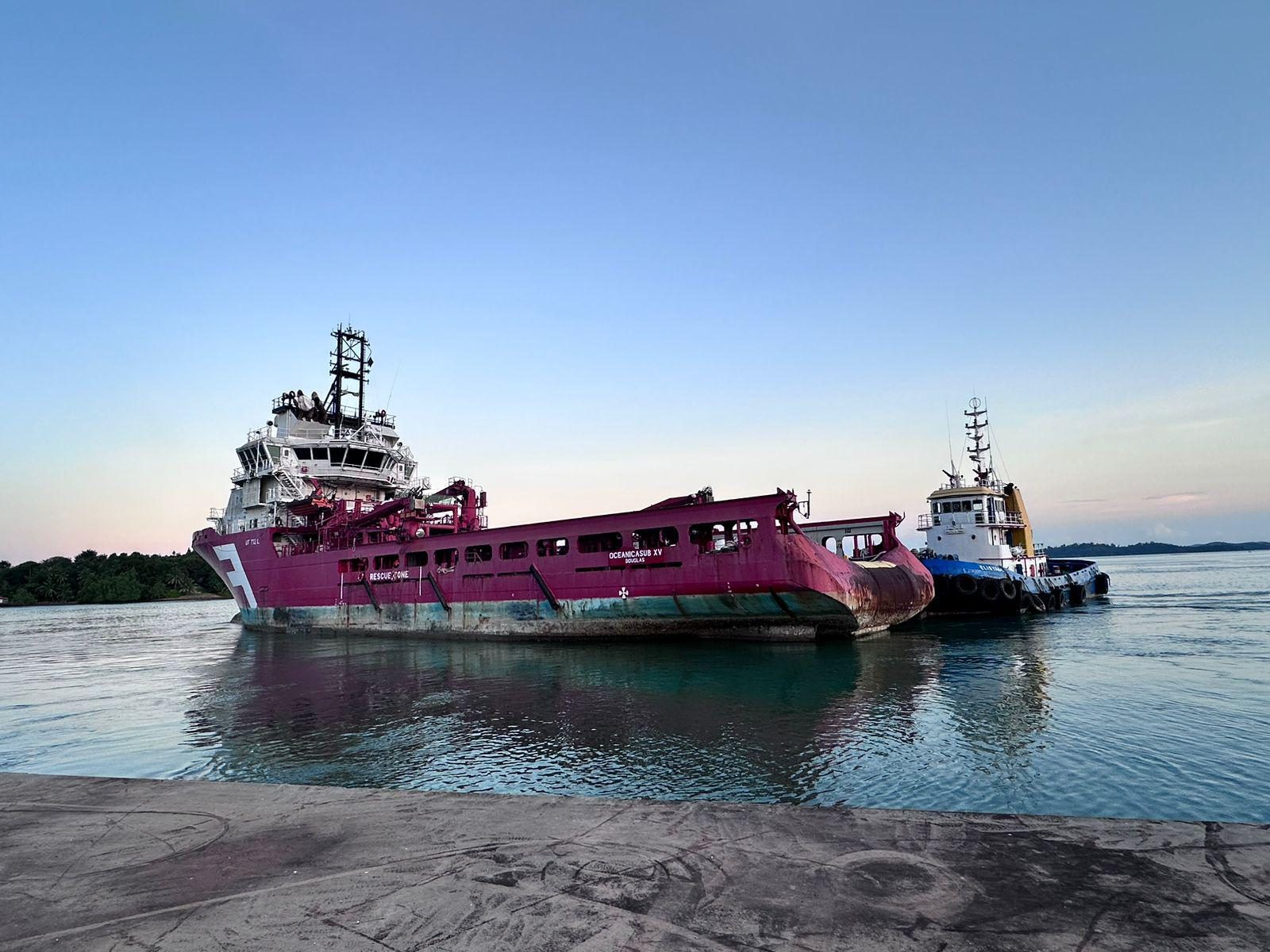 Oceanicasub XV under tow at dusk in primer-coated hull, already bearing her new name ahead of final livery.