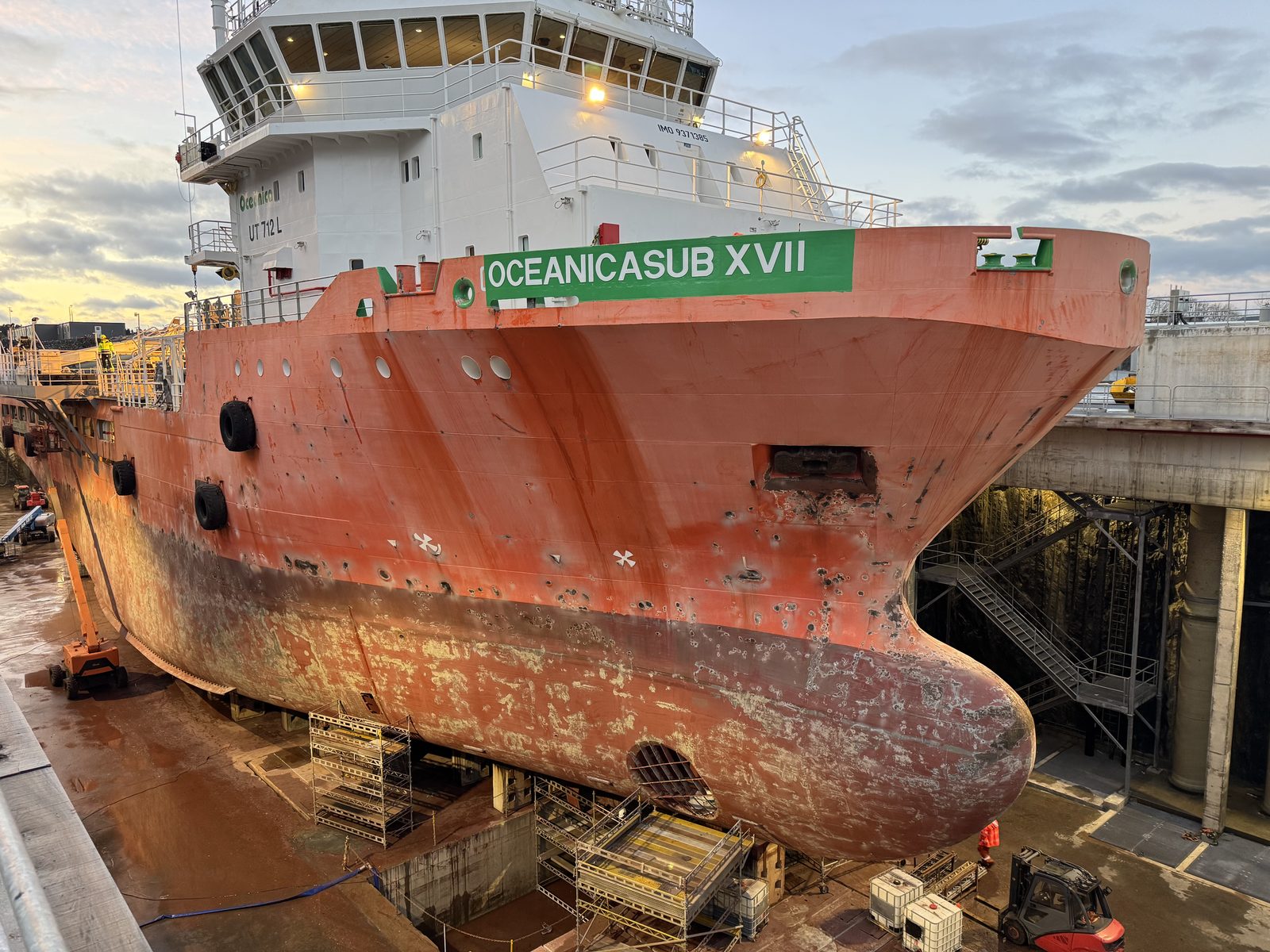 Oceanicasub XVII's hull freshly painted with her new name in dry dock, hull otherwise still in as-acquired rust-red condition, UT 712 L design marking visible on the superstructure.