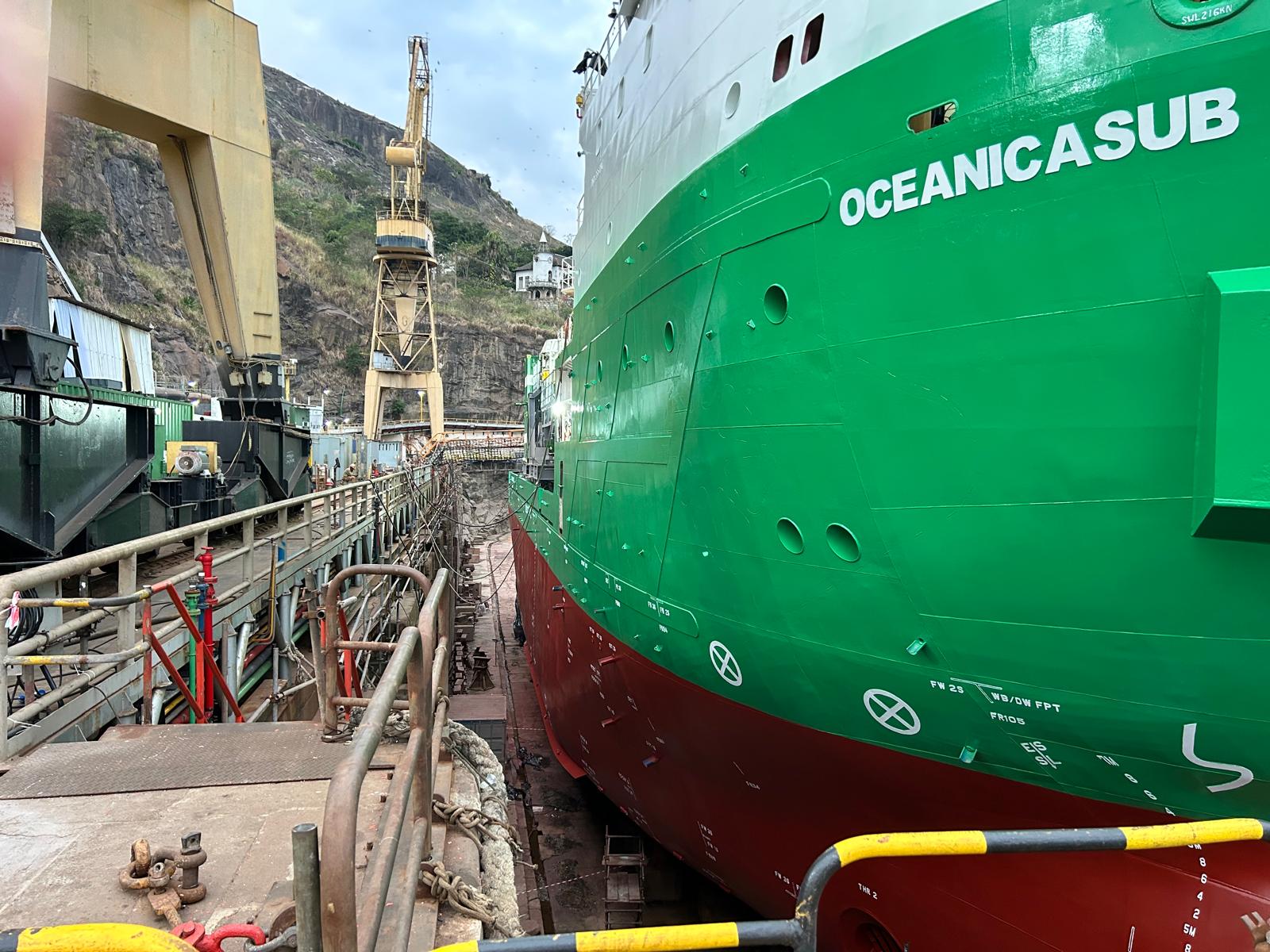 Close-up bow view of Oceanicasub XII in drydock, green and red hull livery