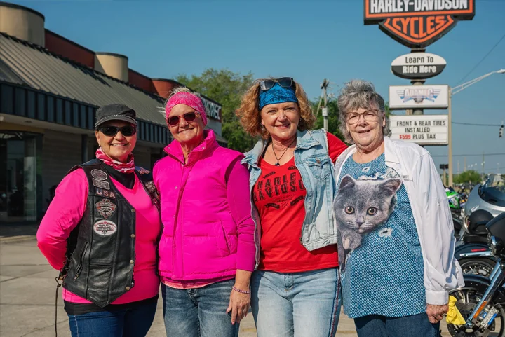 A group of women Hogs For Dogs riders posing at Adamec Harley-Davidson