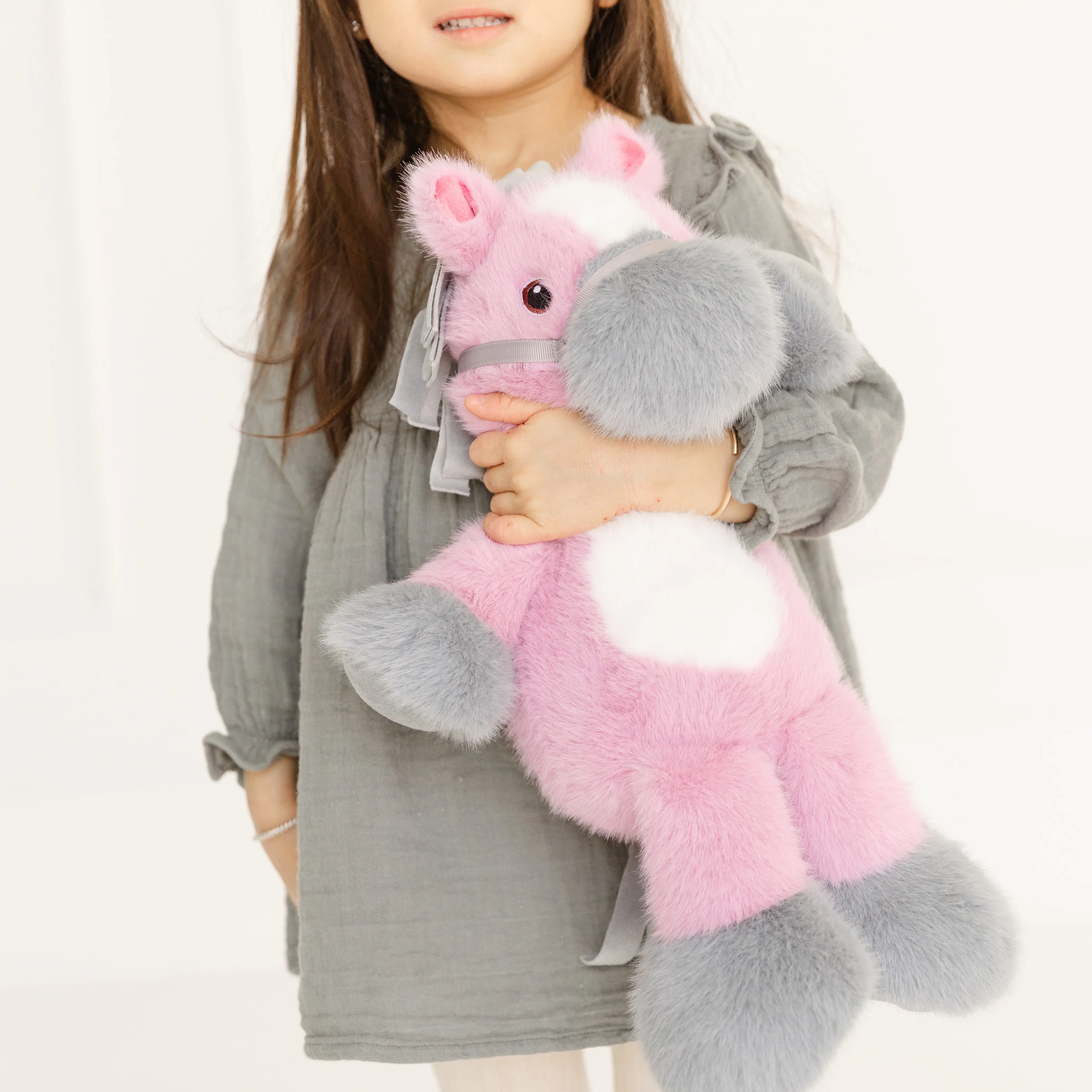 A girl holds a mauve Coccoloni horse