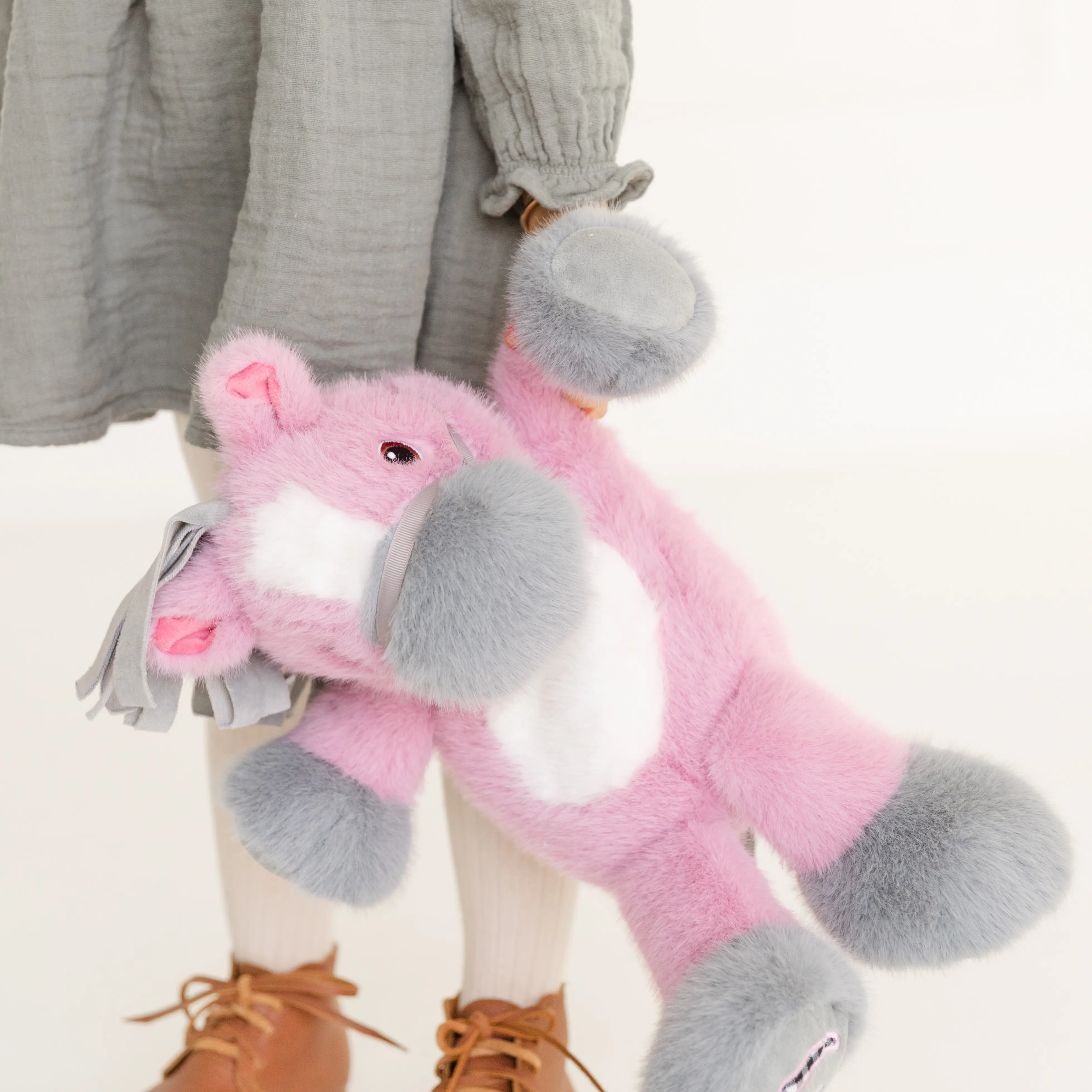 A girl holds a mauve Coccoloni horse