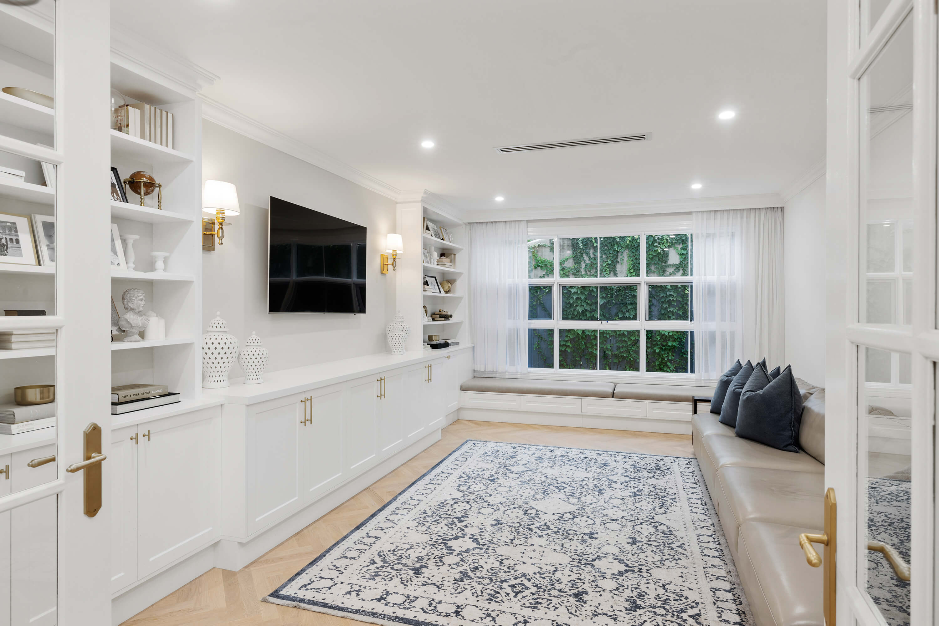 Custom built entertainment unit with integrated storage and shelving
