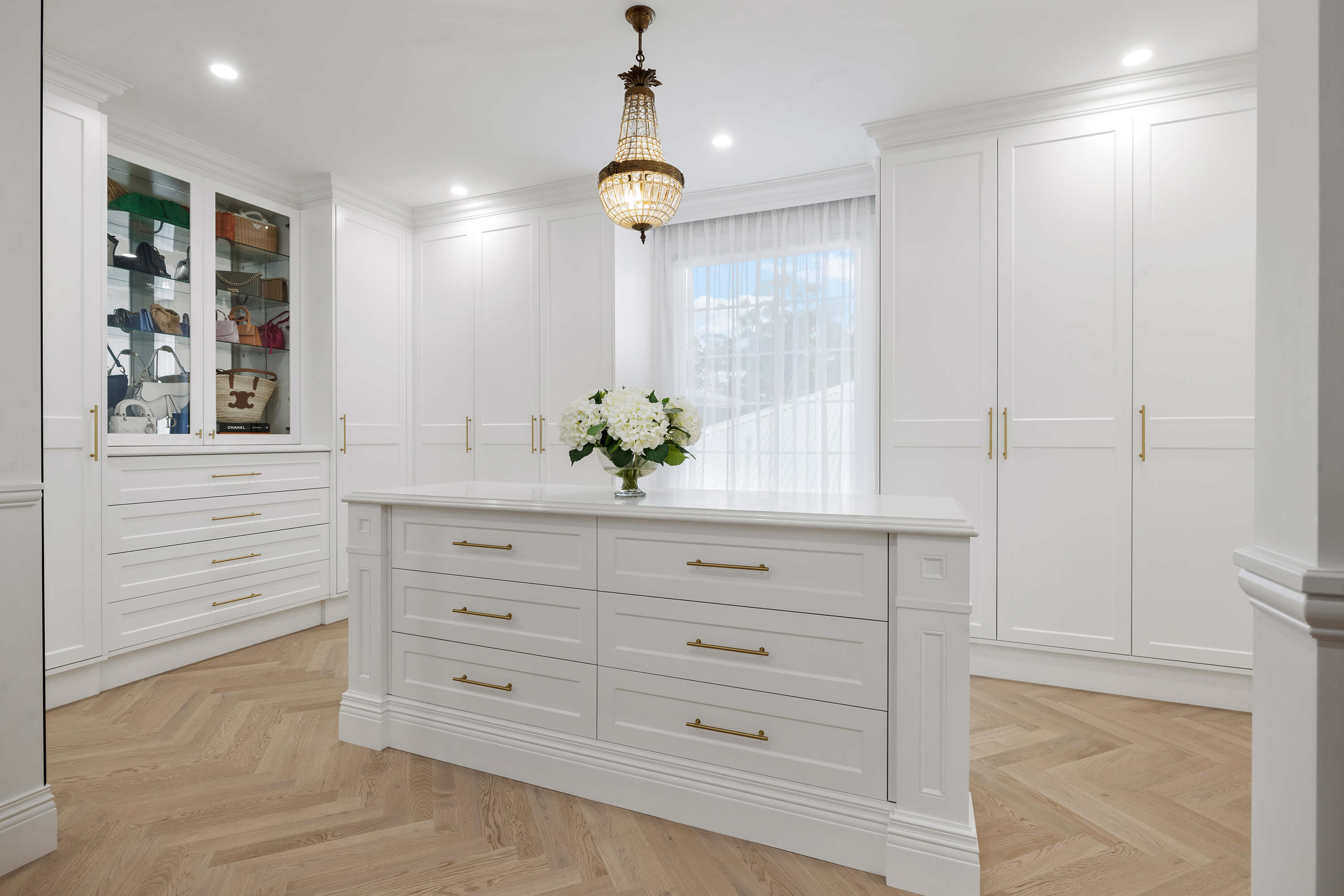 Walk-in wardrobe with custom cabinetry and organised storage layout