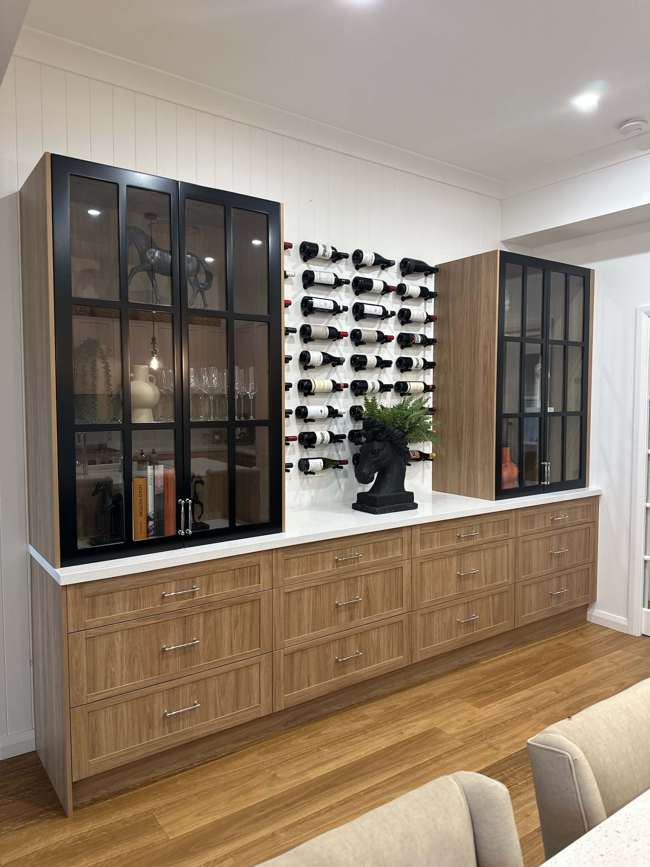Custom wine display cabinetry with feature shelving and lighting