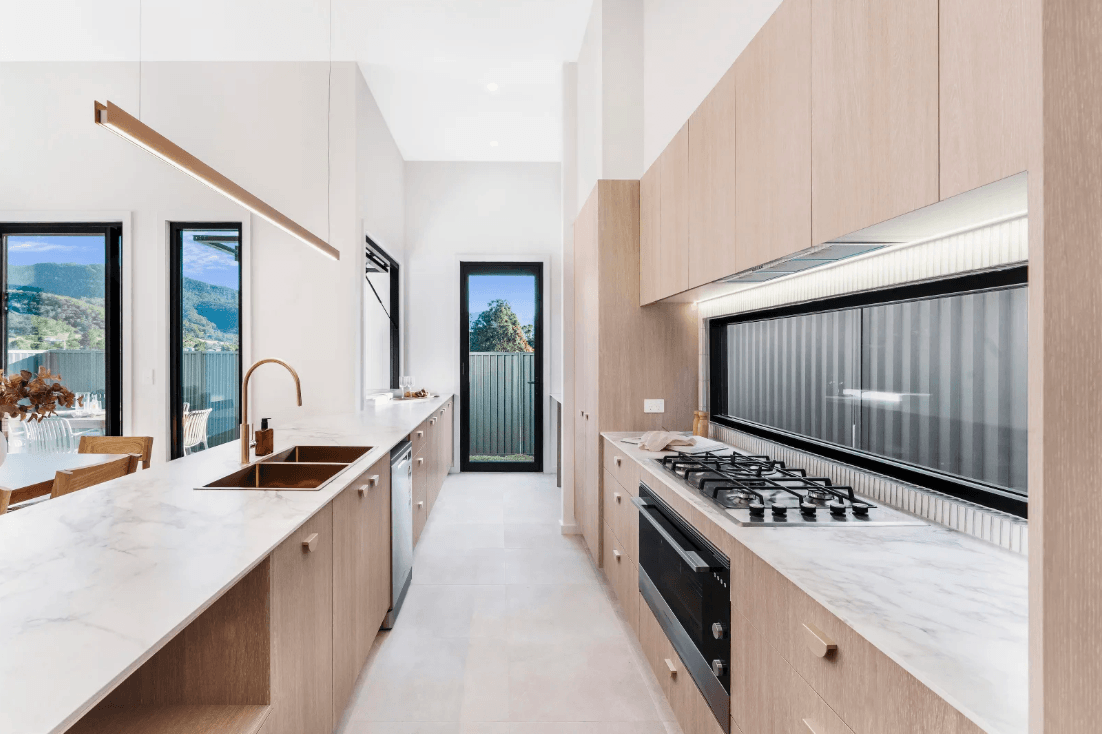Contemporary kitchen with island bench and integrated appliances