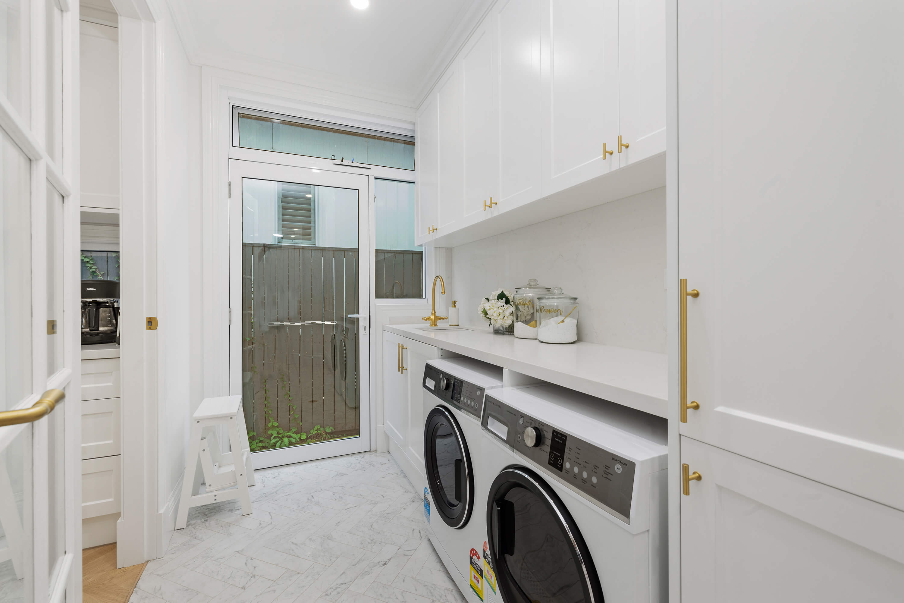 Custom laundry cabinetry with practical storage solutions