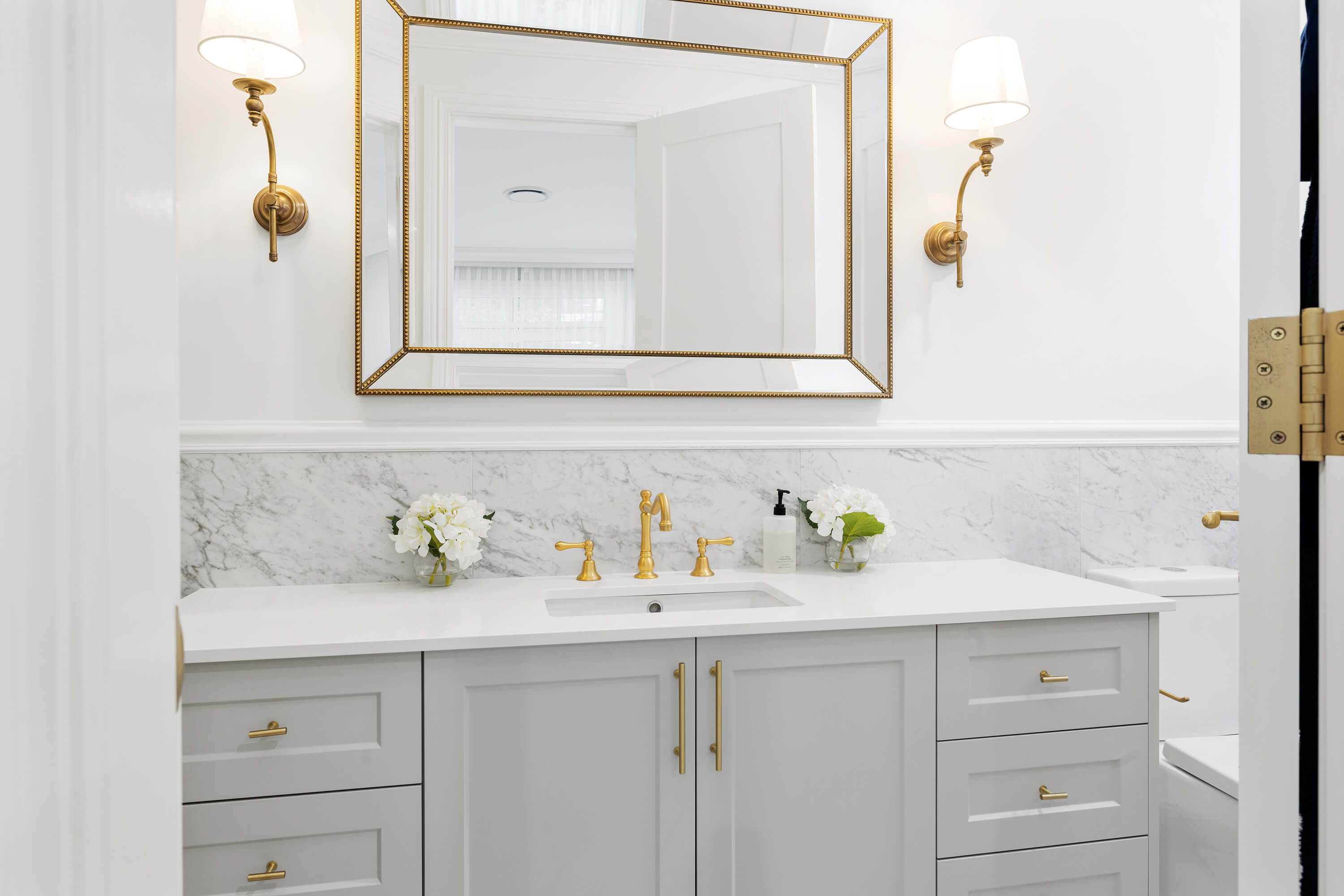 Modern bathroom vanity with custom cabinetry and stone top