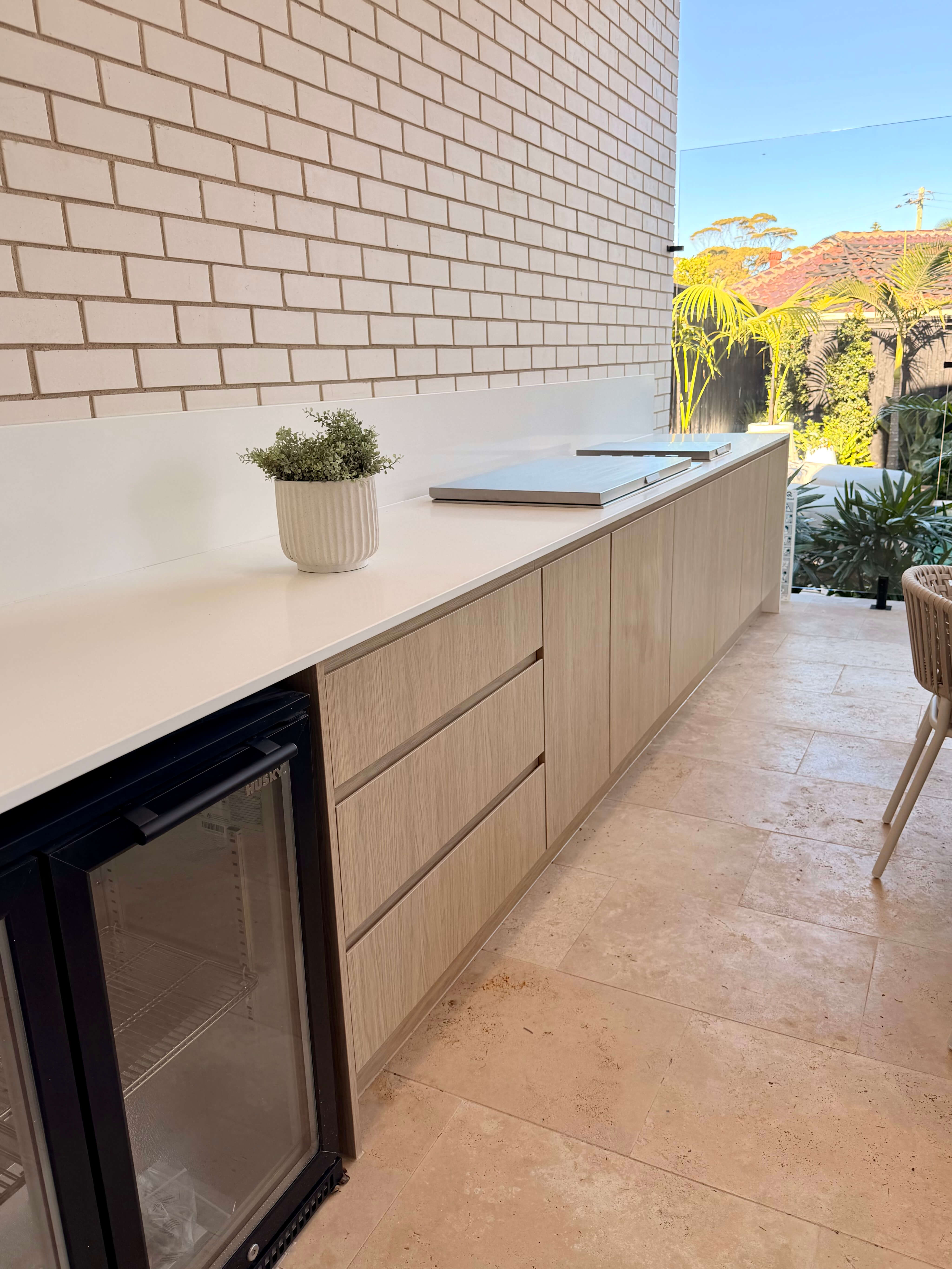 Custom alfresco kitchen featuring a built-in BBQ, bespoke joinery and a stylish outdoor entertaining space.