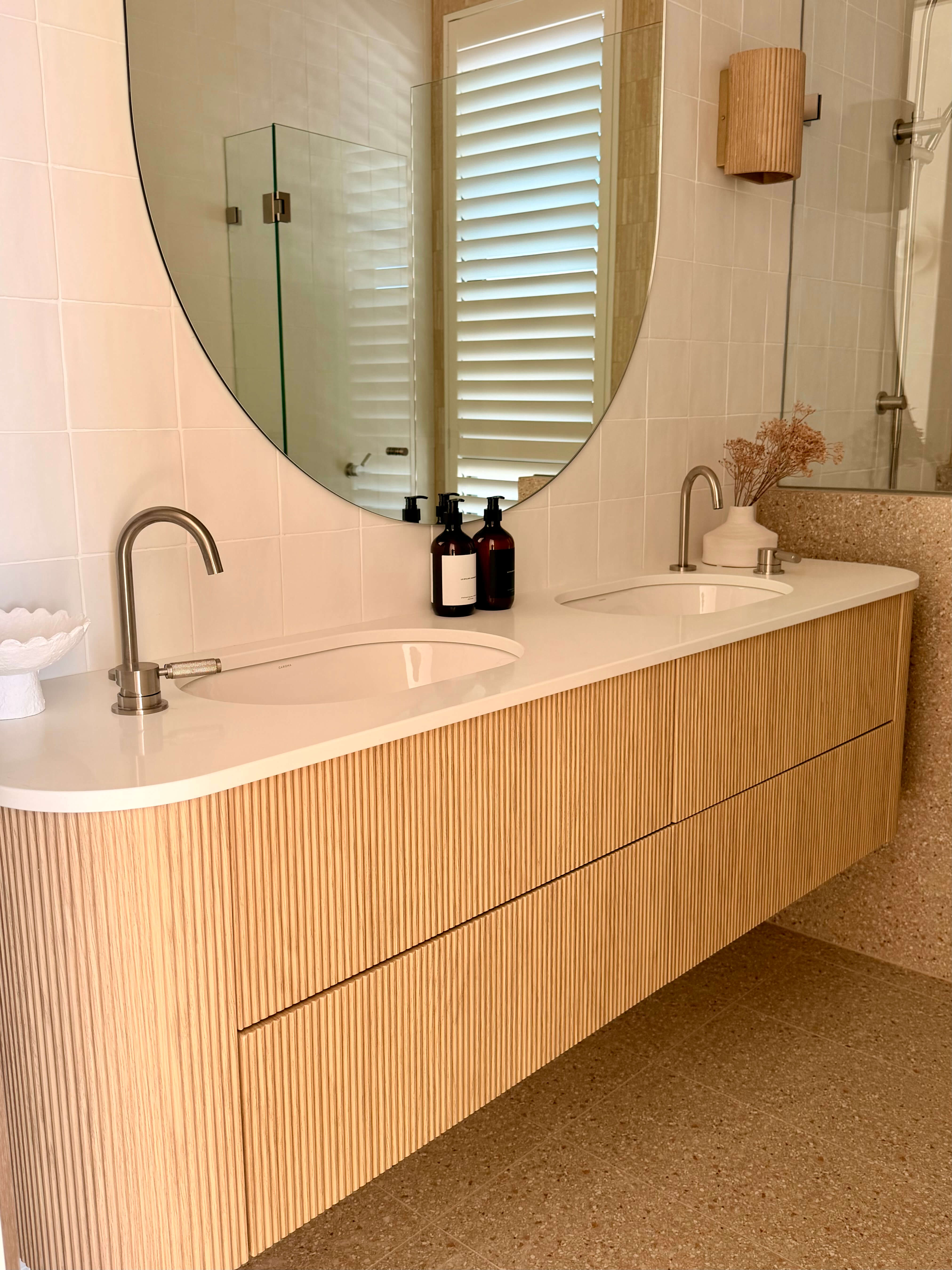 Modern custom vanity featuring sleek cabinetry, a contemporary sink and functional bathroom storage.