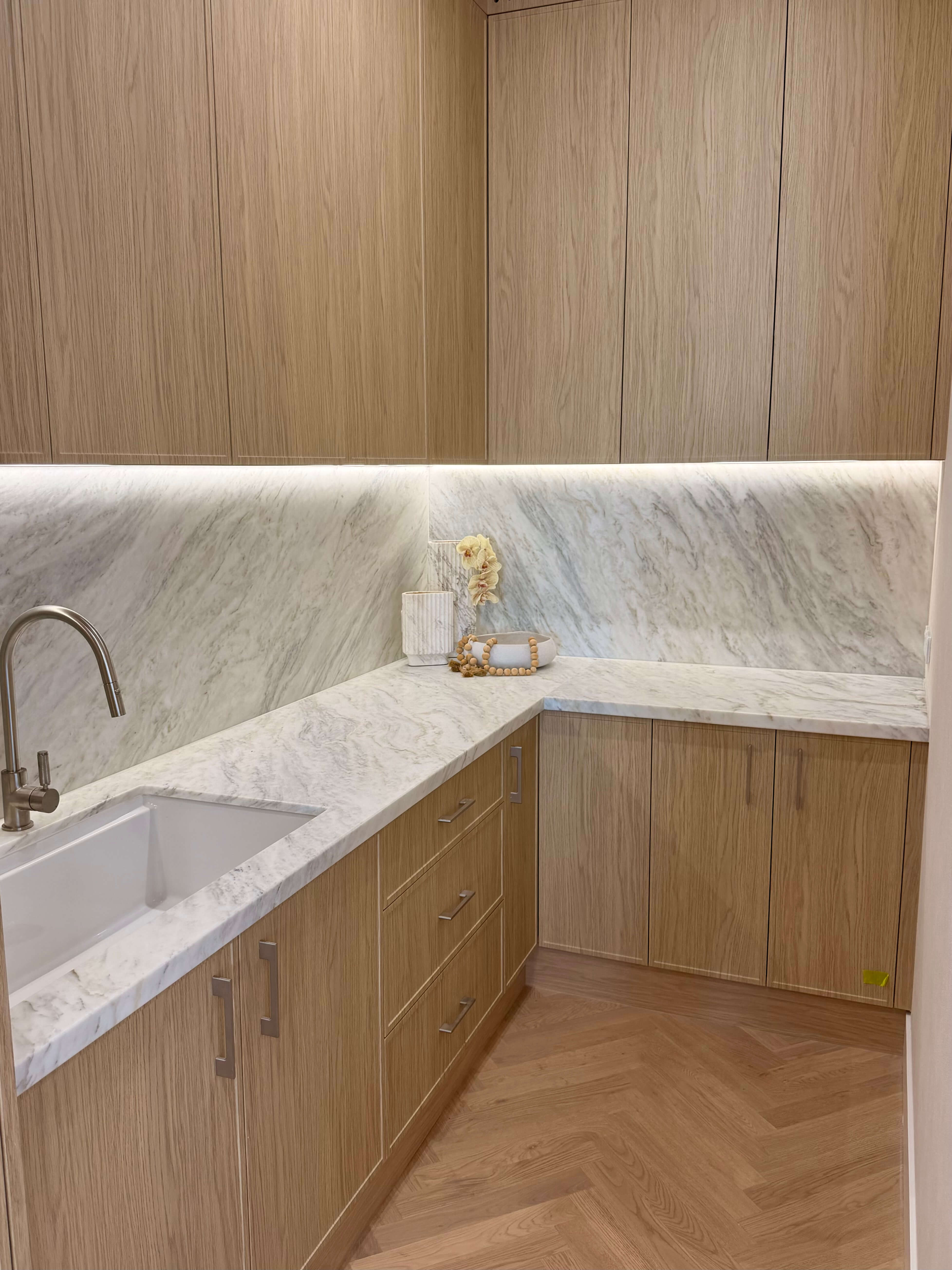 Luxury butler's pantry showcasing bespoke cabinetry, warm finishes and smart storage solutions.