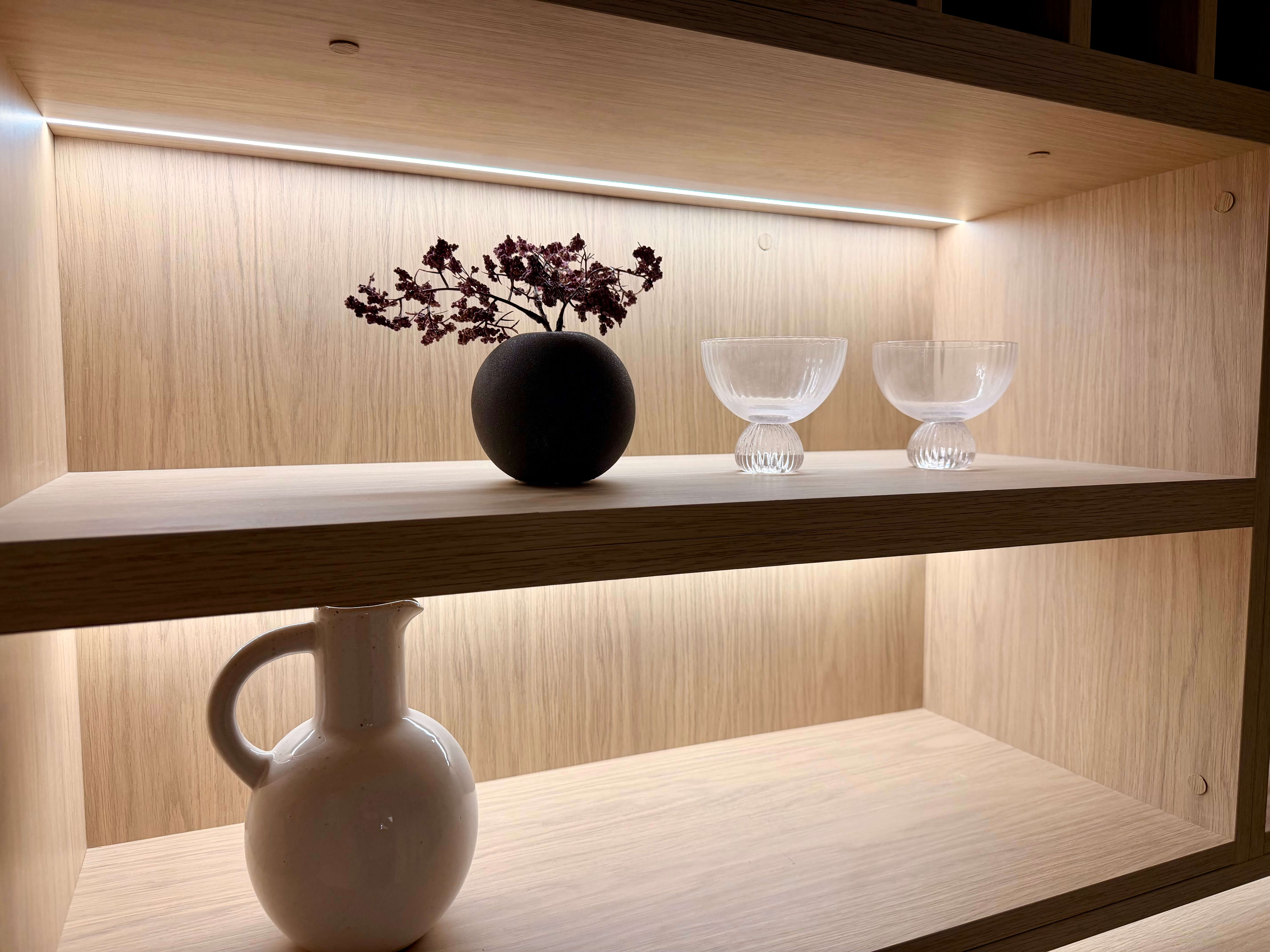 Custom backlit wine cellar with bespoke cabinetry and premium wine storage solutions.