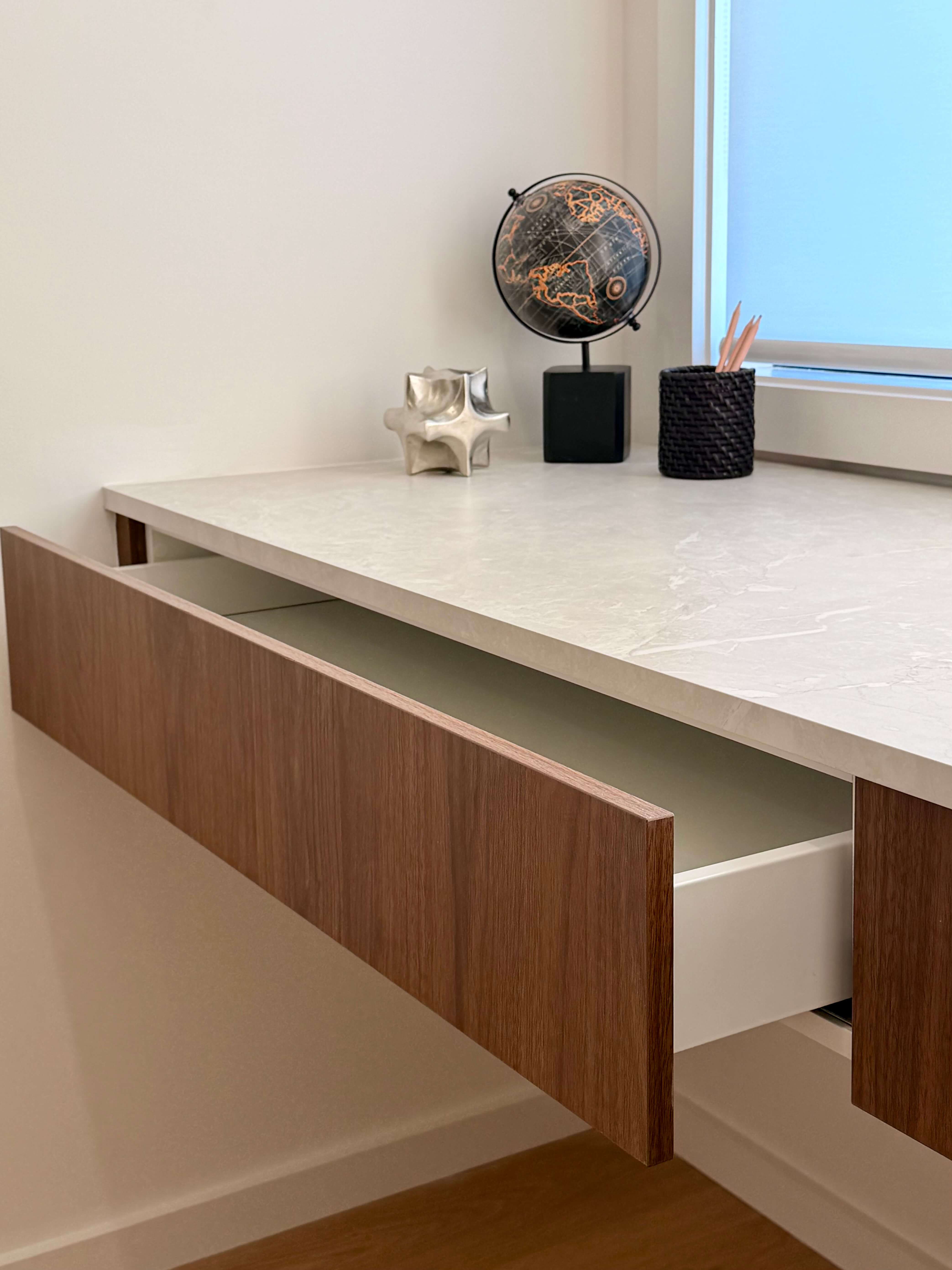 Custom study nook featuring a marble stone desktop, integrated drawer storage and bespoke joinery.