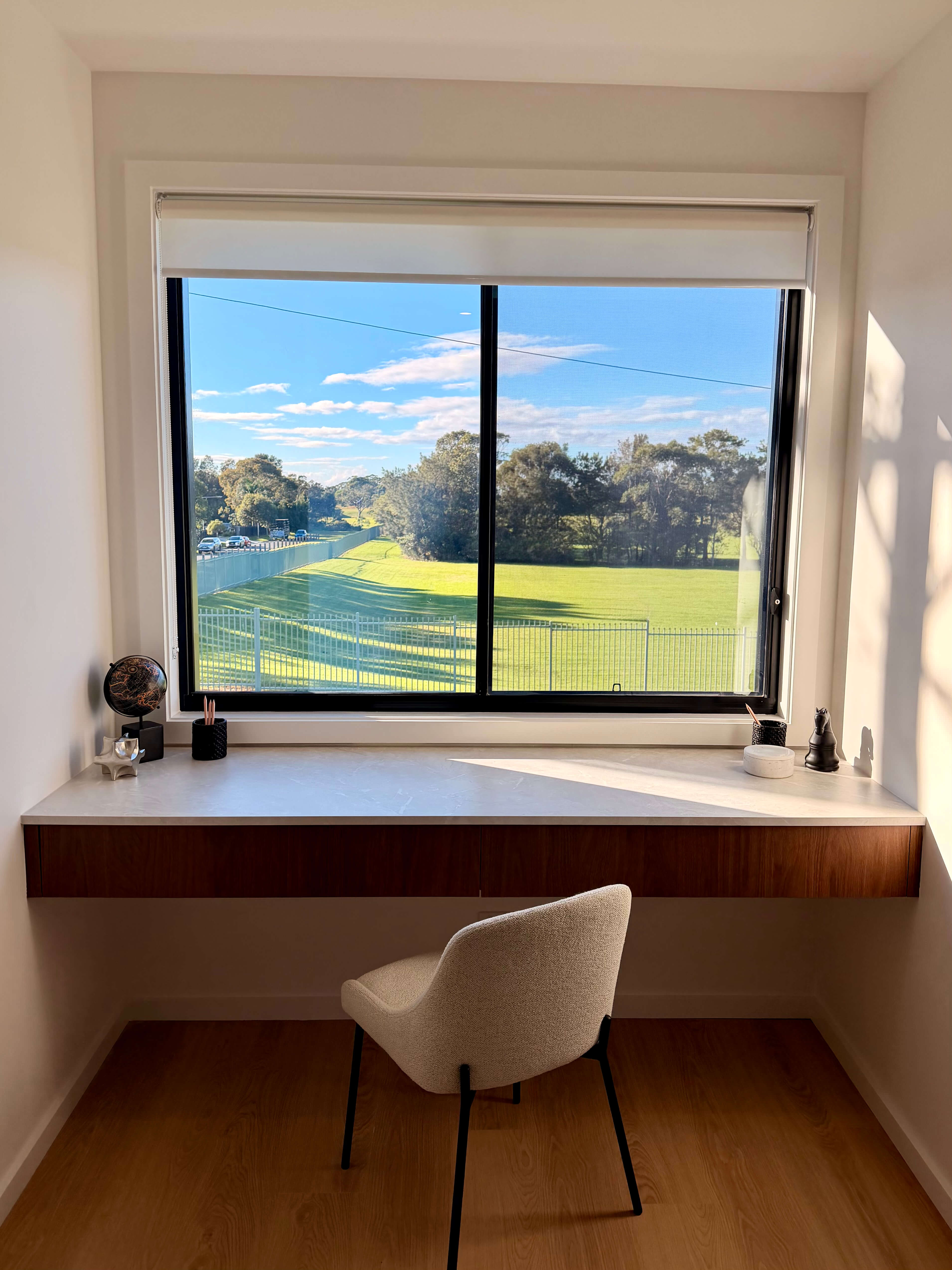 Built-in study nook with bespoke joinery, practical drawer storage and a light-filled window workspace.