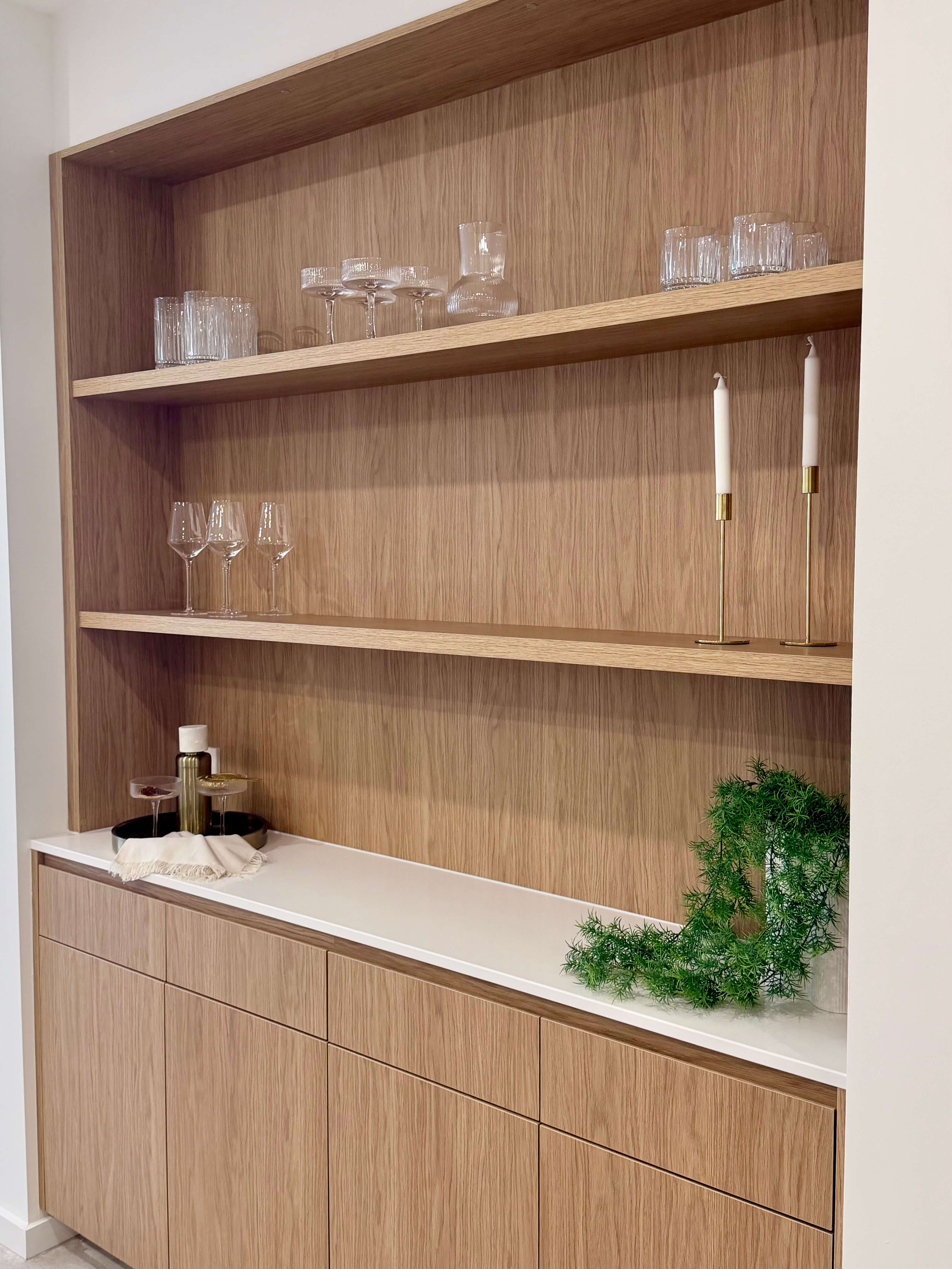 Built-in cocktail bar showcasing custom joinery, wall-mounted shelving and elegant display storage.