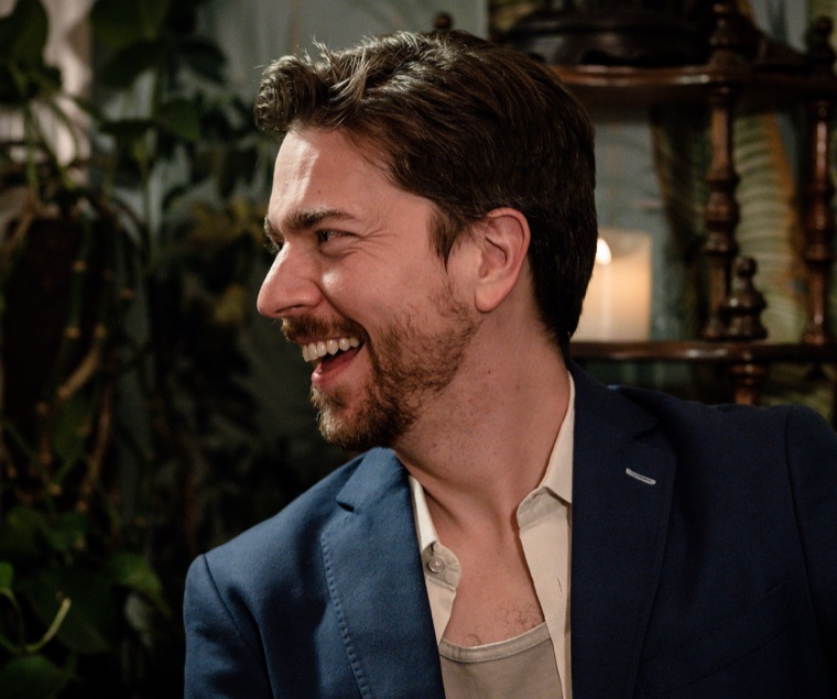 Marcus Phillips laughing, photographed at the Erstwhere speakeasy