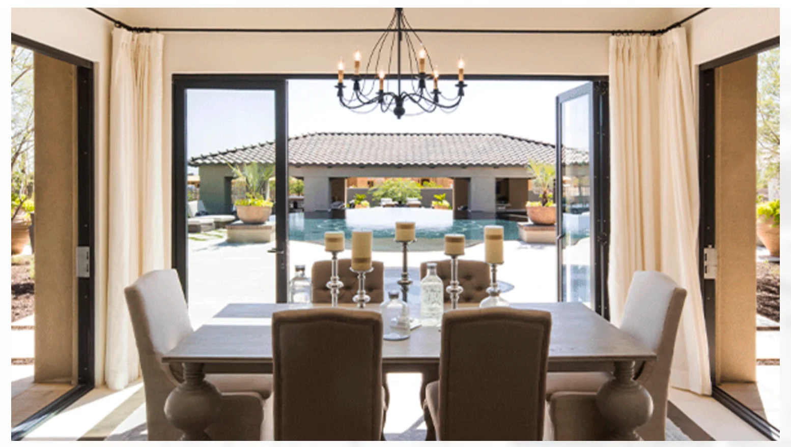 Image of Milgard's Aluminum AX650 Moving Glass Walls Opening from a Dining Room to a Pool.
