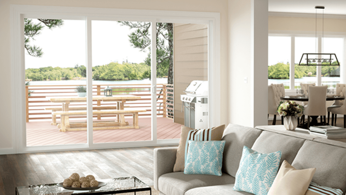 Image of Milgard V400 Tuscany Sliding Patio Doors Opening from a Living Room to a Deck.