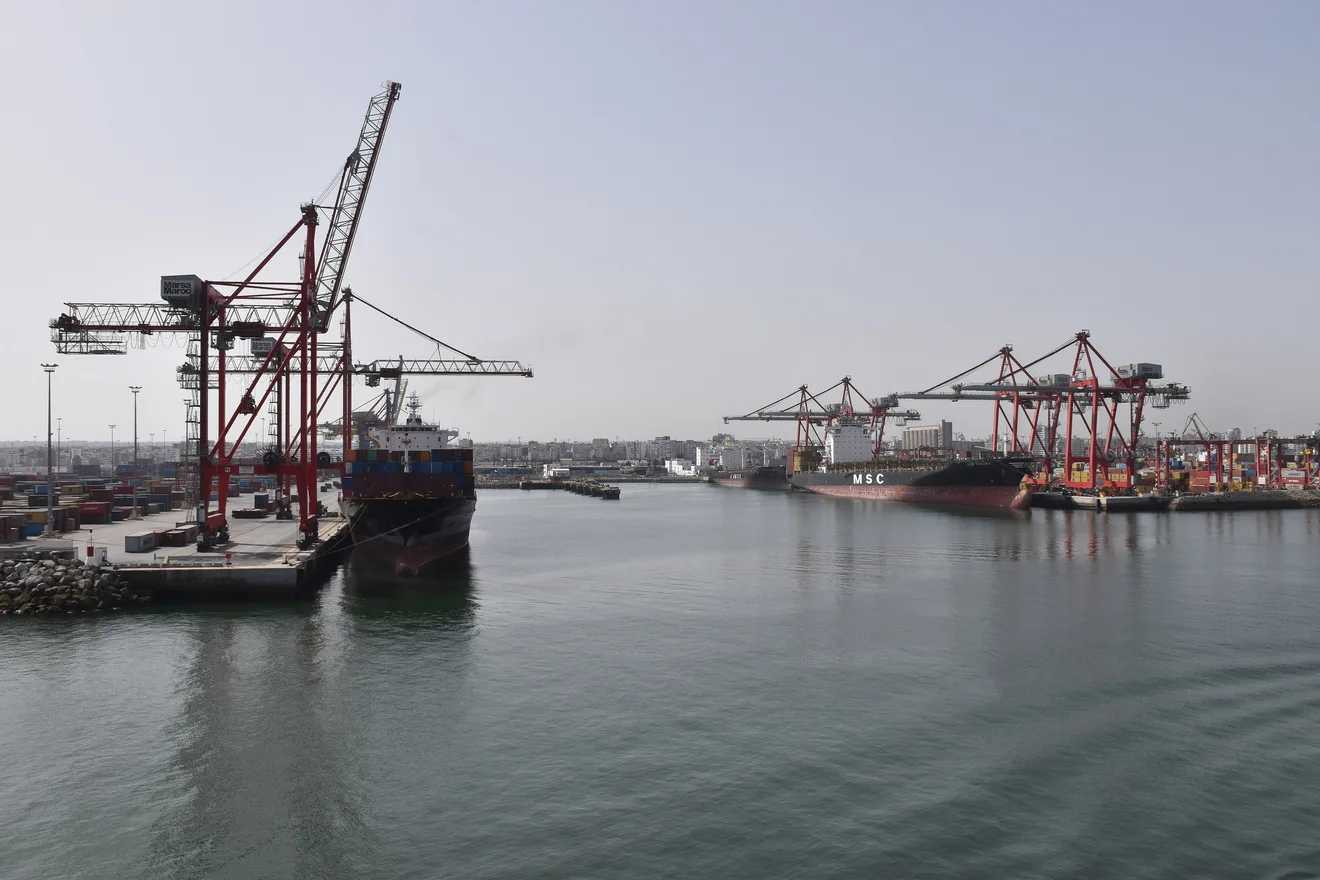 The Casablanca container port, its red gantry cranes and two container ships at the quay, photographed in August 2023.