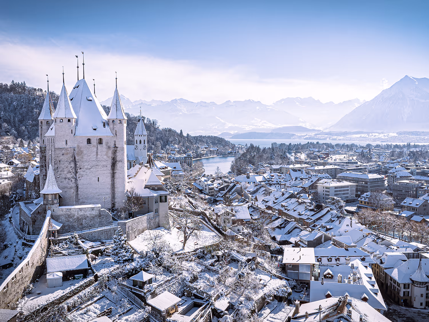 Thun in winter - enchanted snowy landscape with a view of Thun Castle