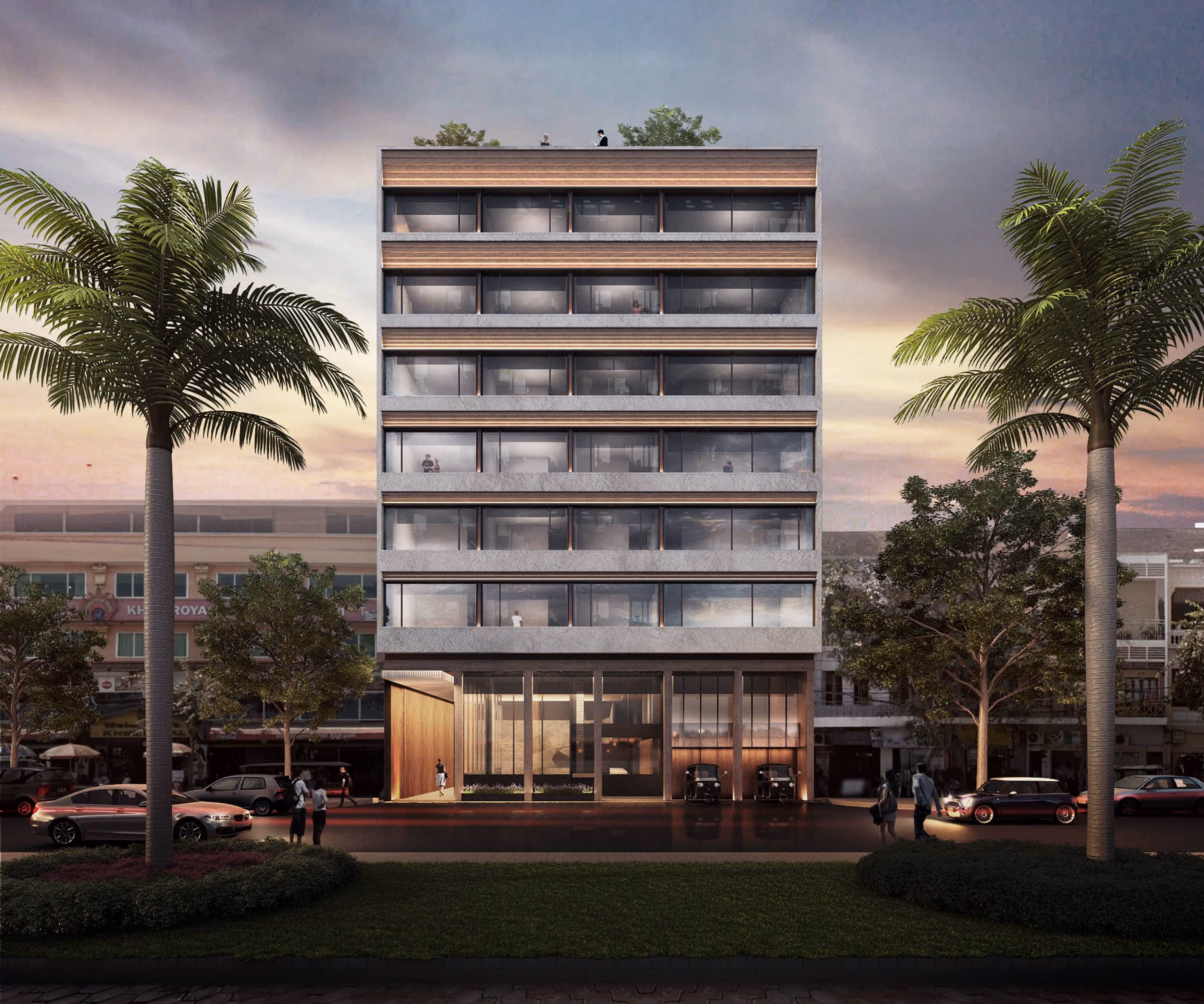Modern six-story building with floor-to-ceiling windows at dusk, flanked by palm trees and parked cars.