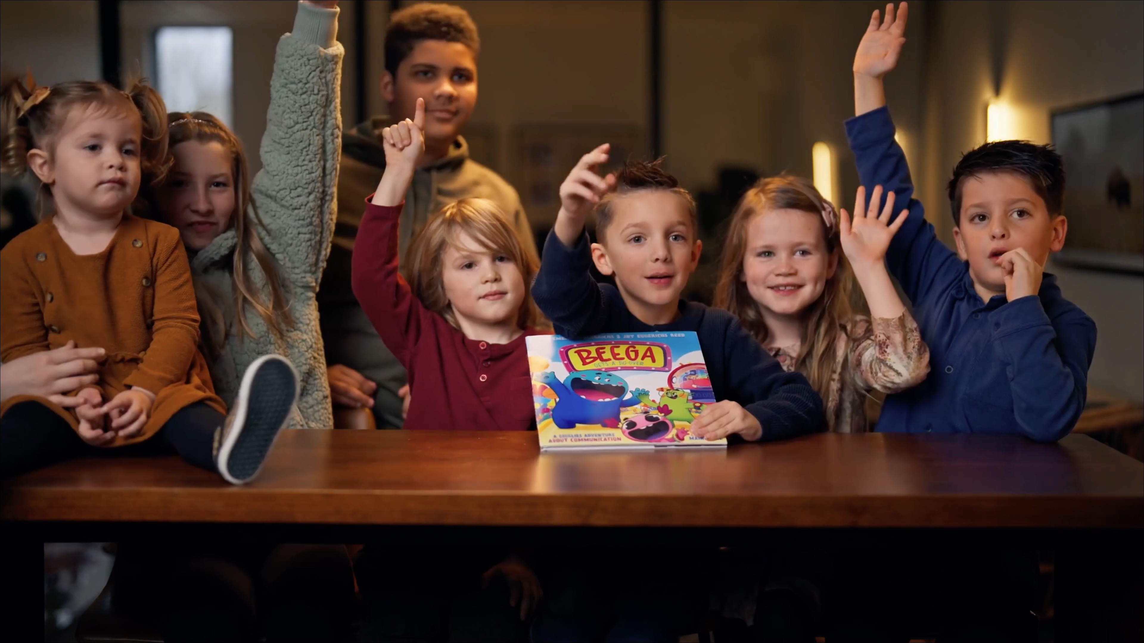 cute kids smiling raising their hands in excitement over a new book they are holding called "Beega Gets A Do-Over" by Emerson Eggerichs and Joy Eggerichs Reed