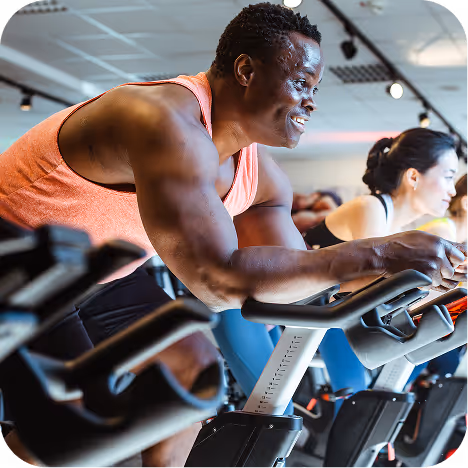 Man working out on exercise bike at a gym