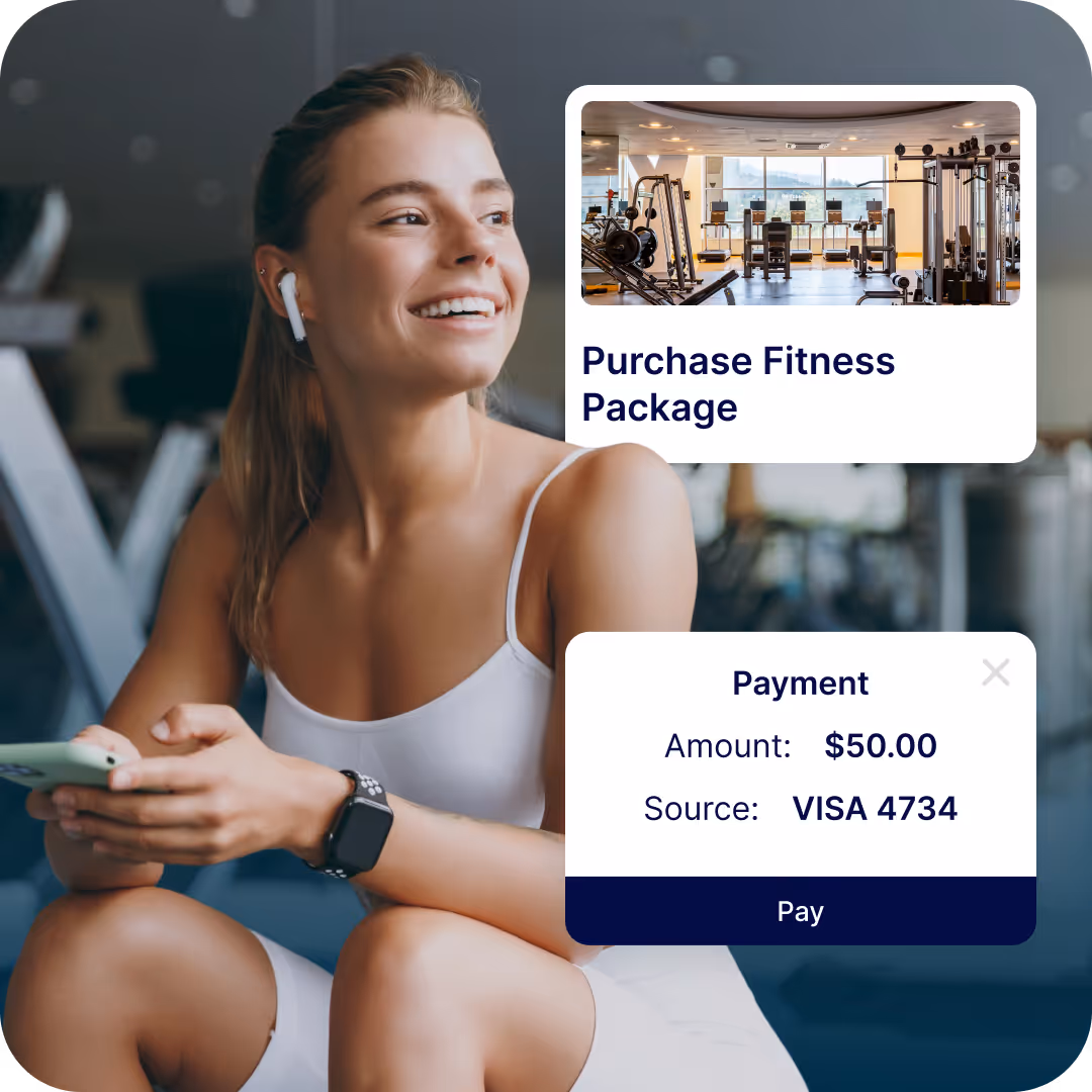 Smiling woman in workout outfit holding phone with fitness package payment overlay on gym background.