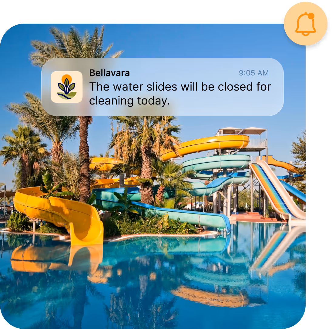 Colorful water slides and palm trees reflected in a pool with a notification about slide closures.