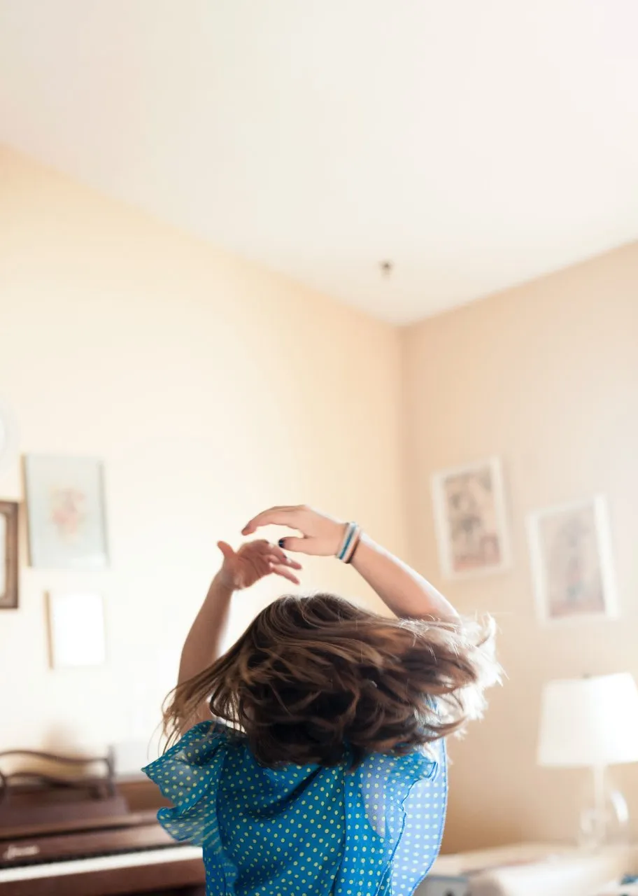A girl dancing in the room.