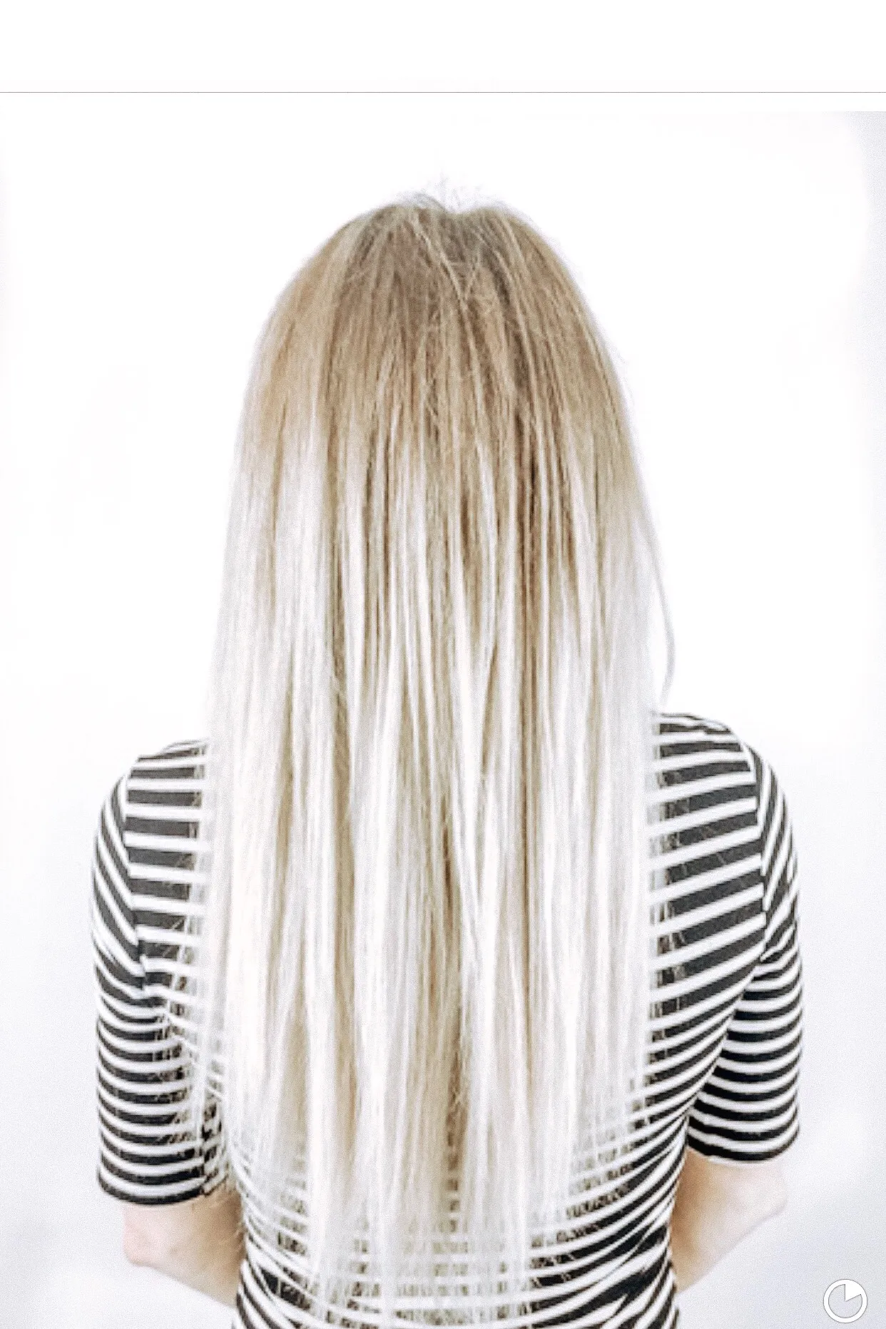 Blonde hair with sparse see-through ends photographed straight from behind