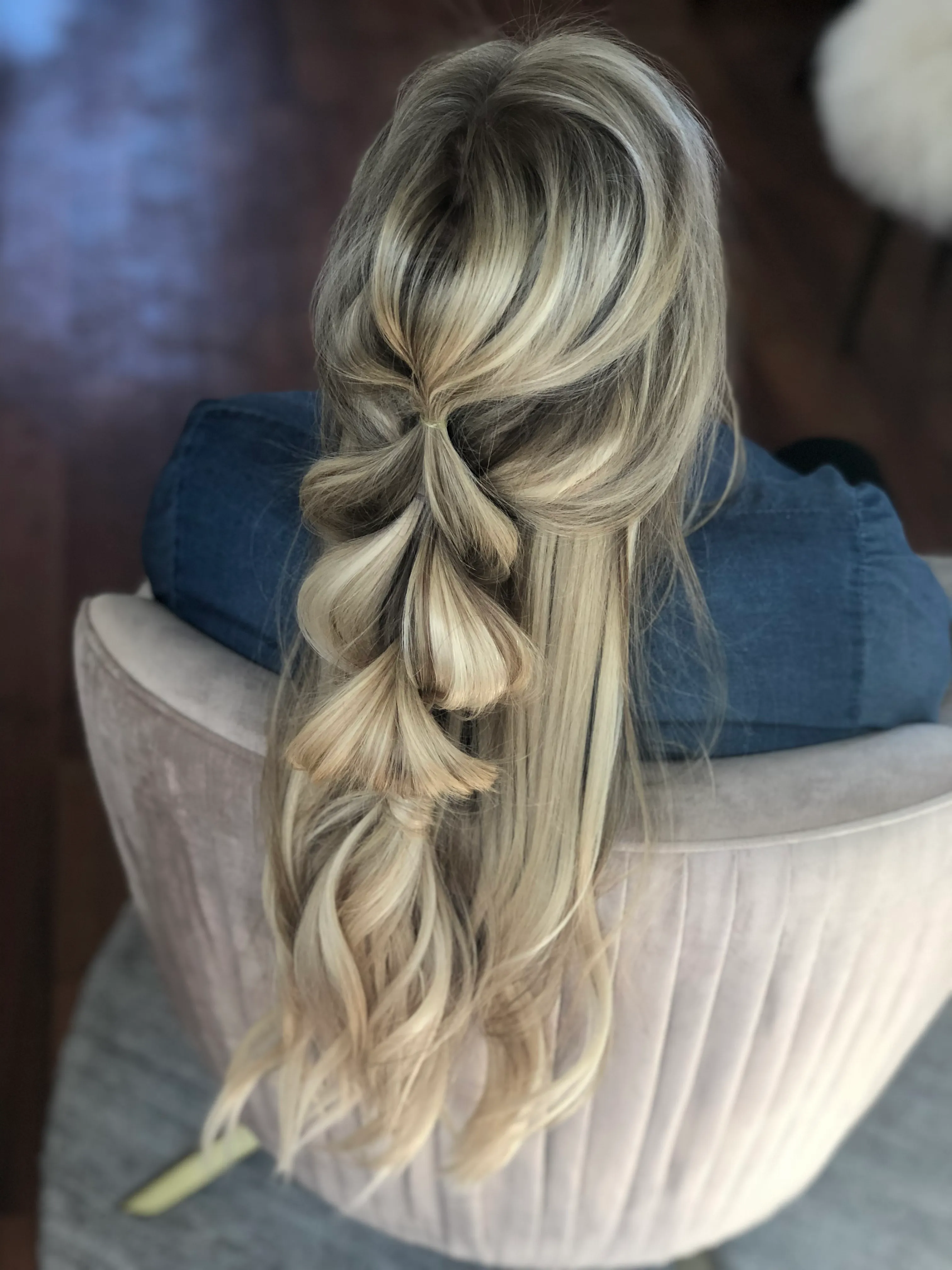 Pull-through braid forming soft bubbles down long blonde hair