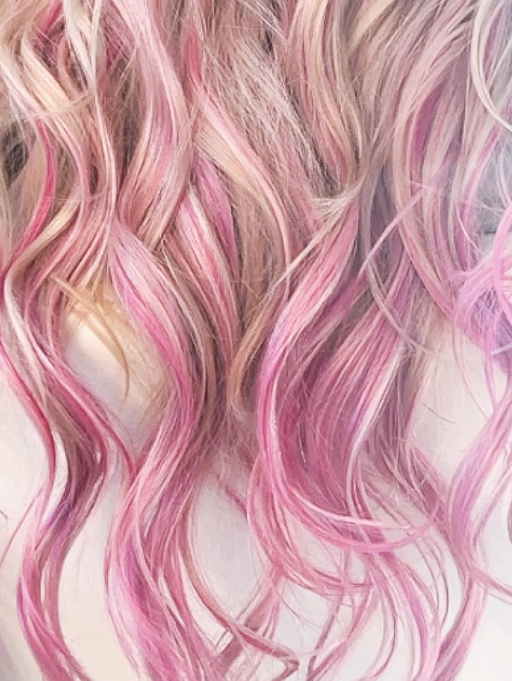Vivid pink hair color on hair extension wefts at Light Styling