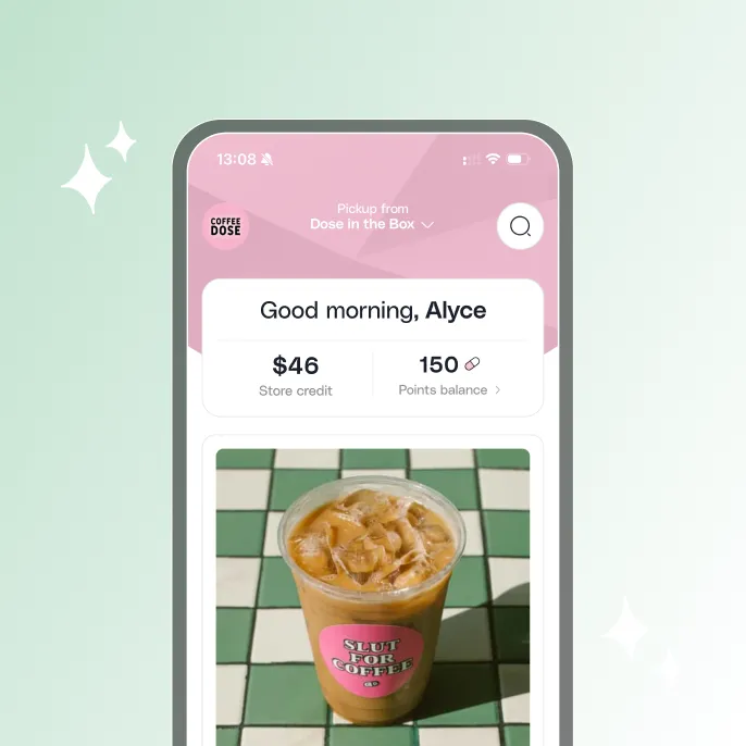 Mobile app screen greeting user Alyce with $46 store credit and 150 points, showing an iced coffee with a pink sticker saying 'SLUT FOR COFFEE' on a green and white tiled table.