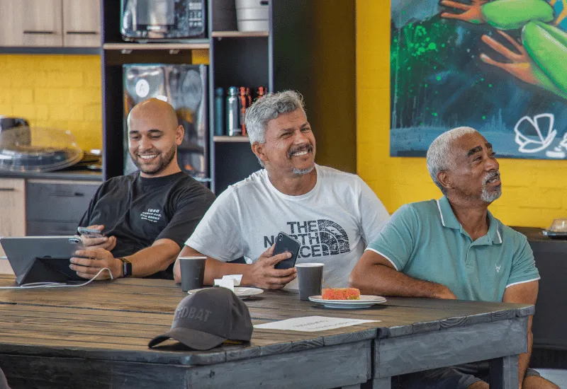 Men listening and smiling together.