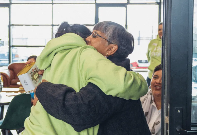 Women hugging one another.