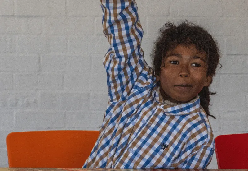 Kid raising their hand.