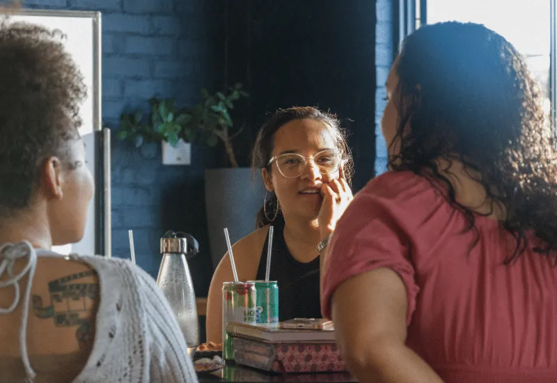 Young adults sharing and chatting with one another.