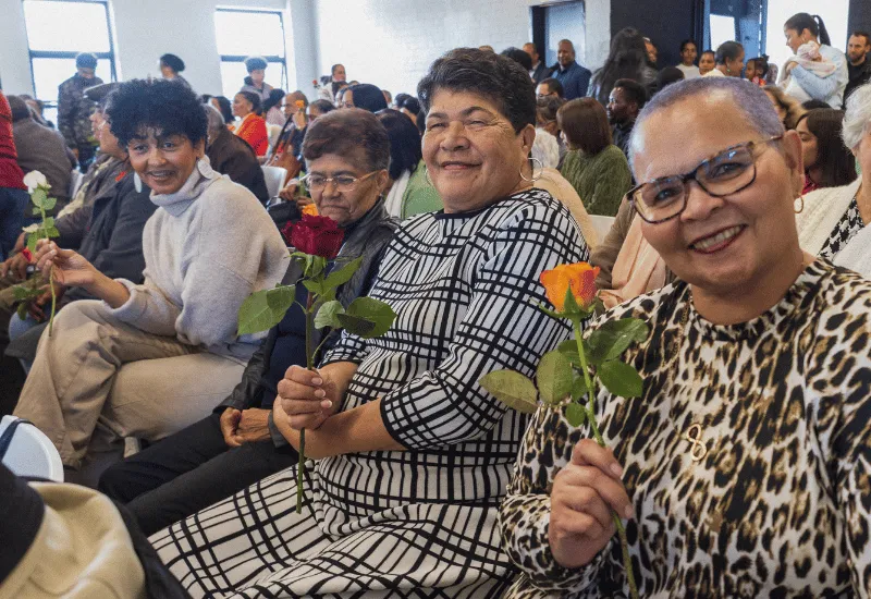 Mothers receiving flowers for mother's day during the service.