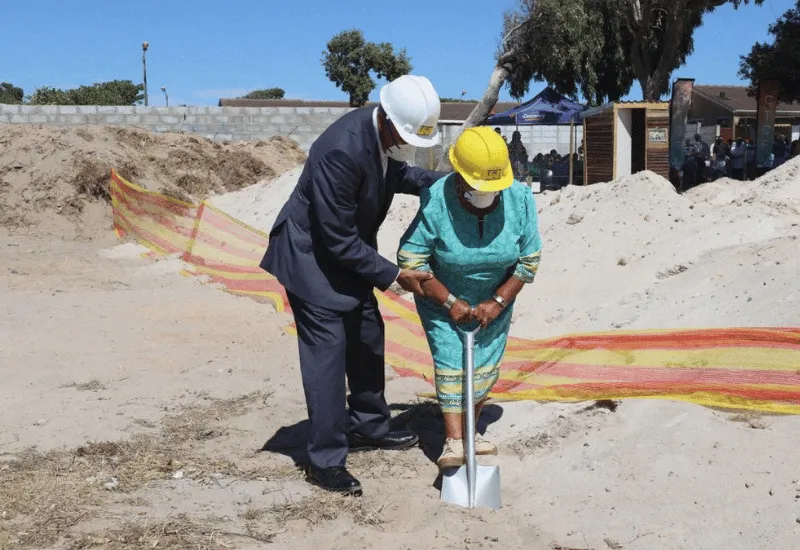 Apostles breaking ground in the sand at the groundbreaking ceremony.