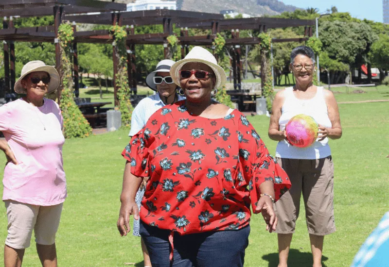 A group of seniors having fun at a park.