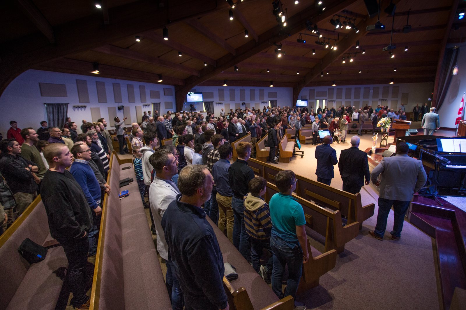 Men standing to sing at the Man-Up Conference