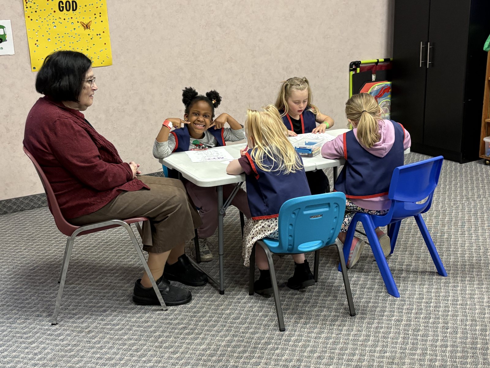 Club book work at the table with a leader
