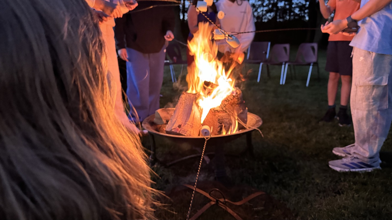 Around the campfire at a youth group night outdoors