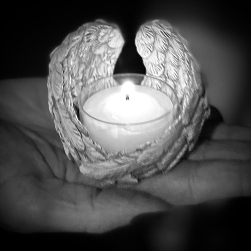 a baby's hand holds a mother's first finger