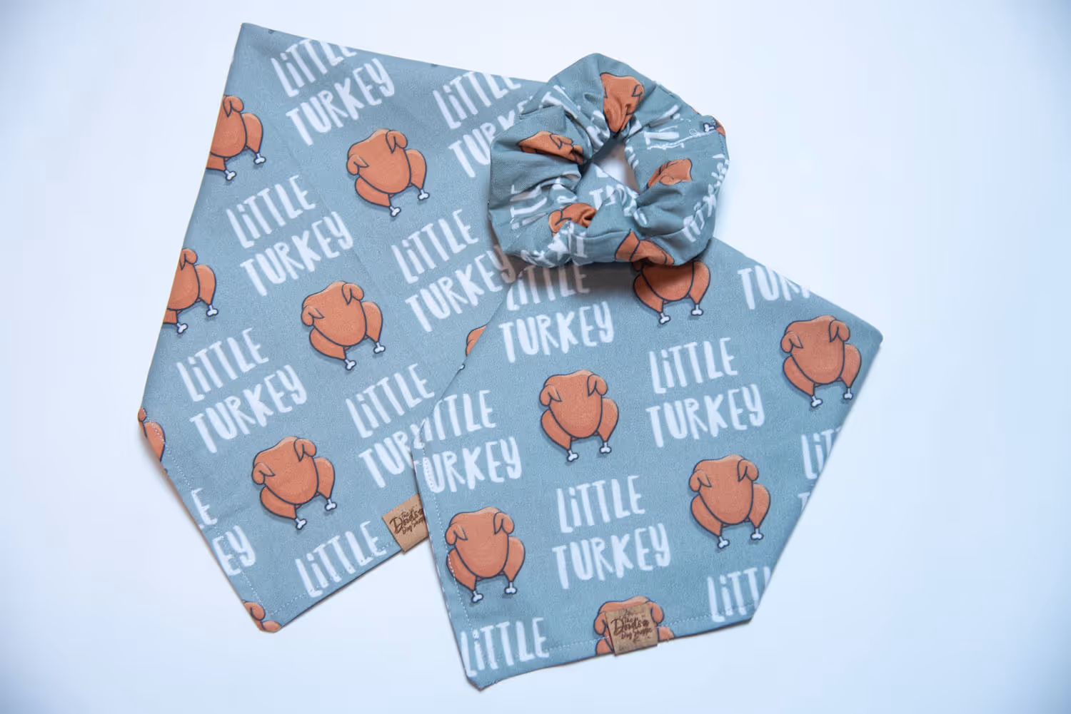 turkey dog bandana overhead laid on a flat surface (x2) with a matching scrunchie