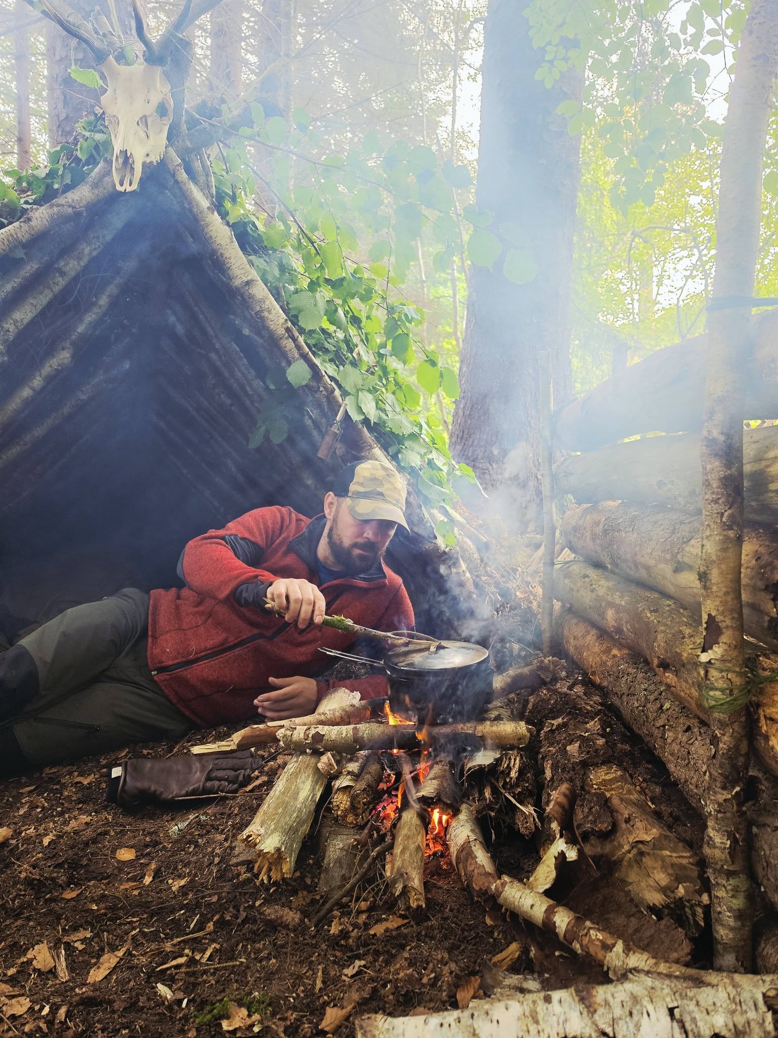 Steven Kelly building a woodland shelter during Highland Reckoning.