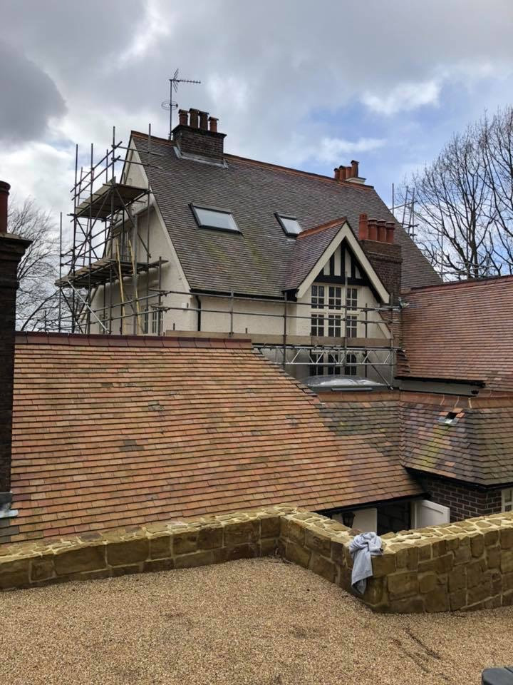 scaffolding on house with sloped roof