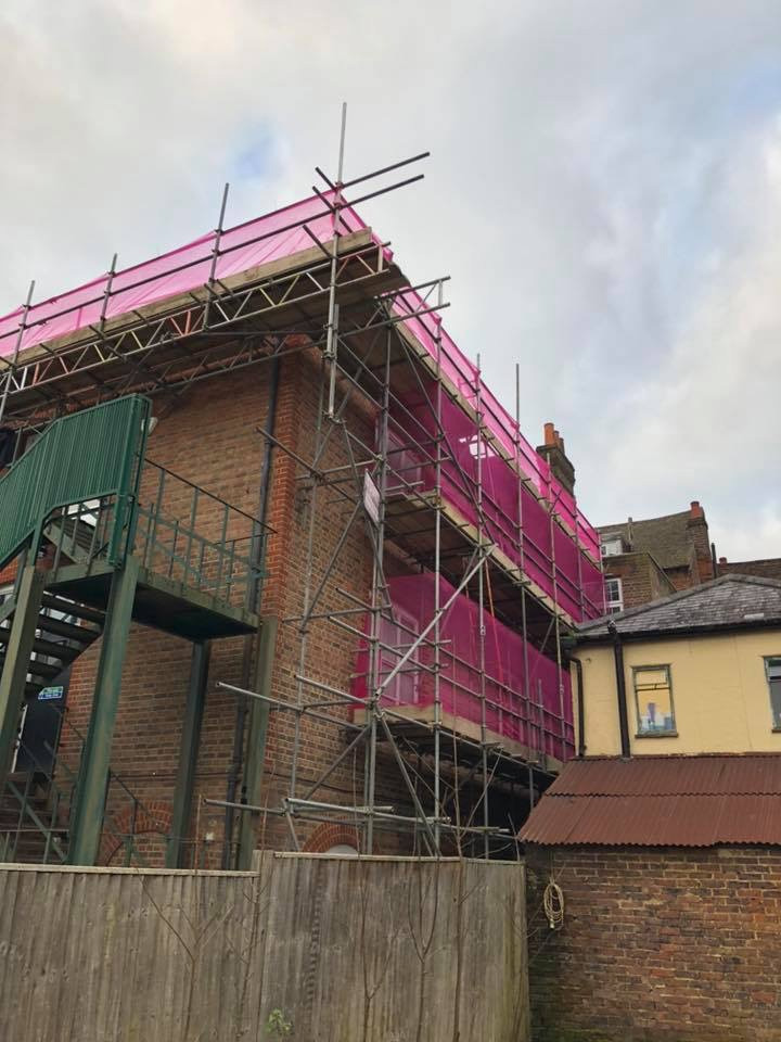 house with pink scaffolding net