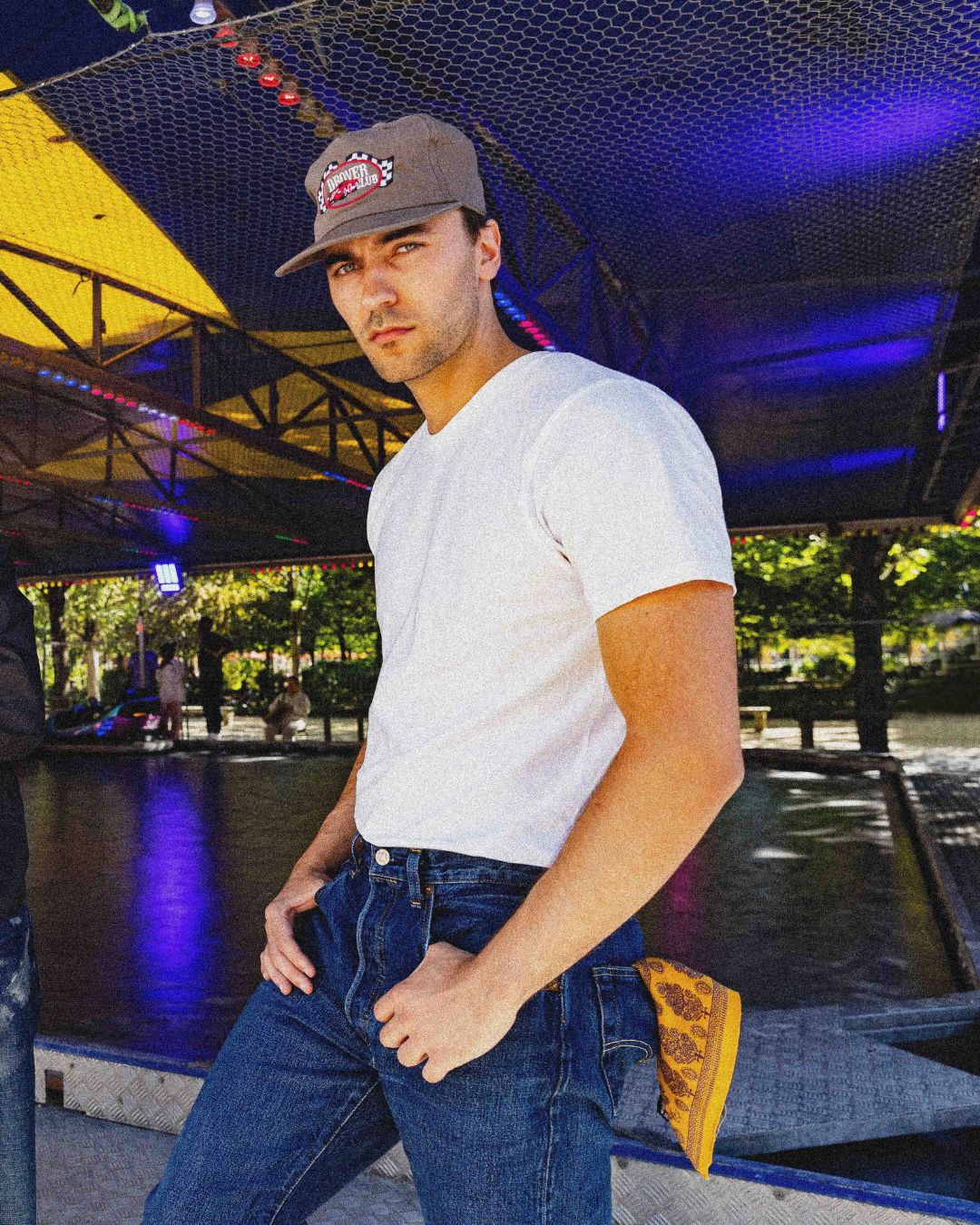 Men's Americana outfit with brown Motor Racing Club 5 Panel cap, white tee and blue jeans styled with yellow bandana.
